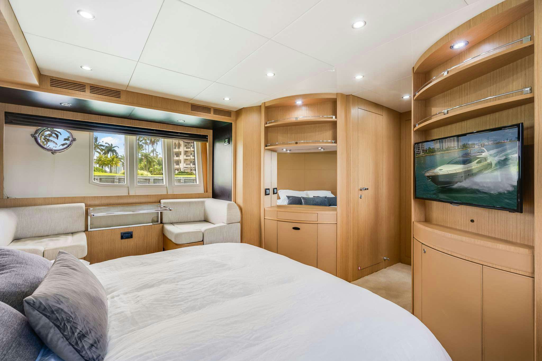 a bedroom with a bed and a tv aboard M3 Yacht for Charter