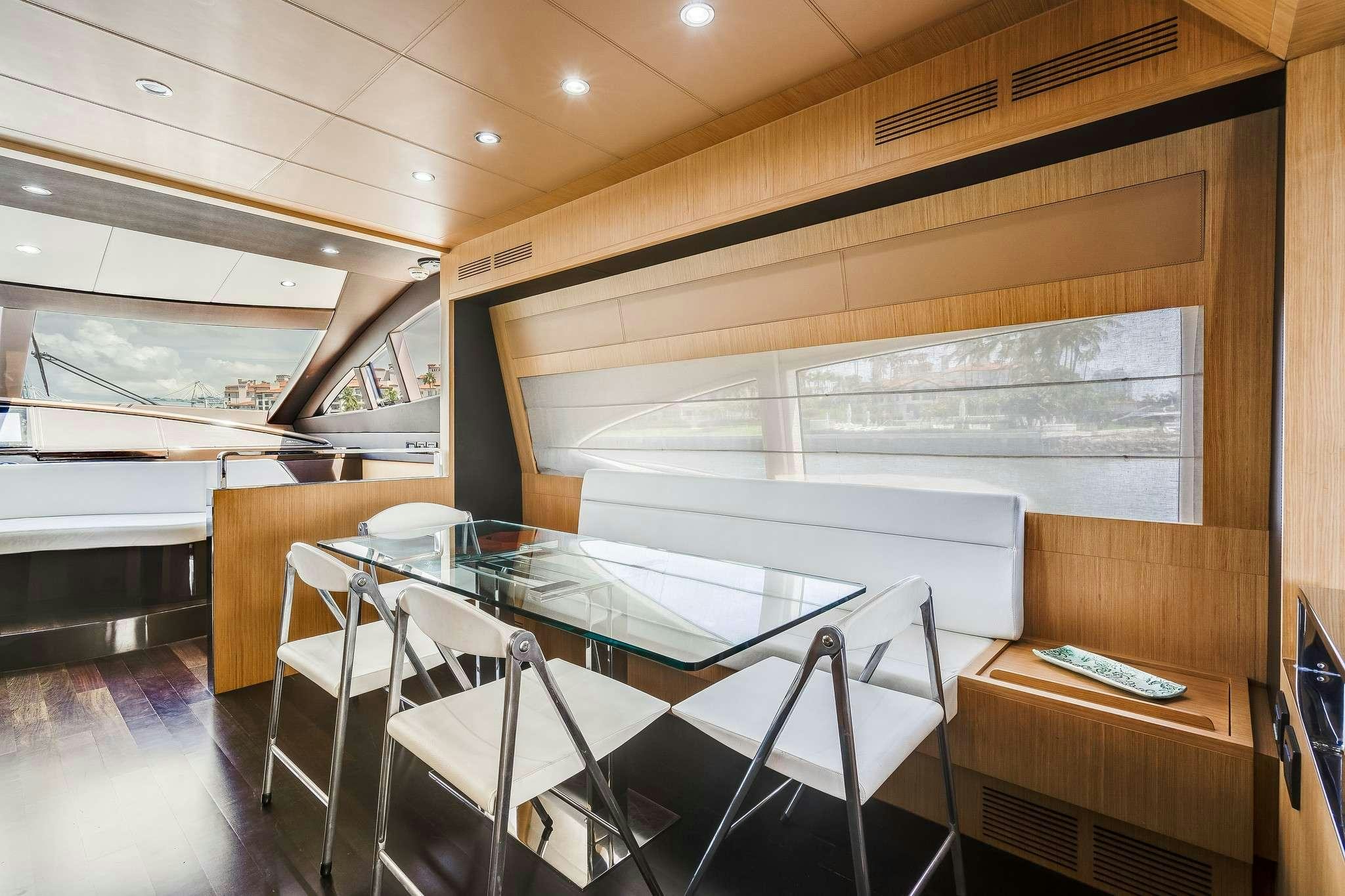 a room with a table and chairs aboard M3 Yacht for Charter