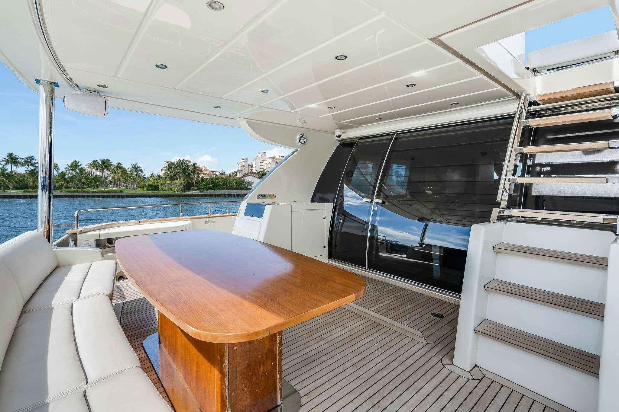 a table and chairs on a deck aboard M3 Yacht for Charter