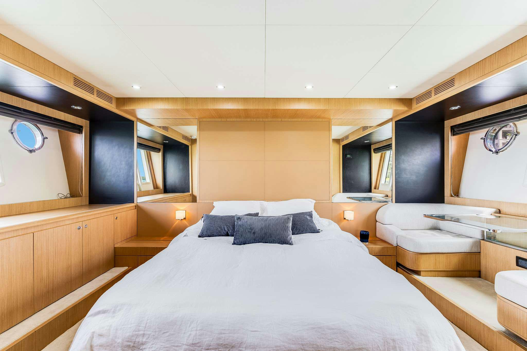 a room with a bed and a mirror aboard M3 Yacht for Charter