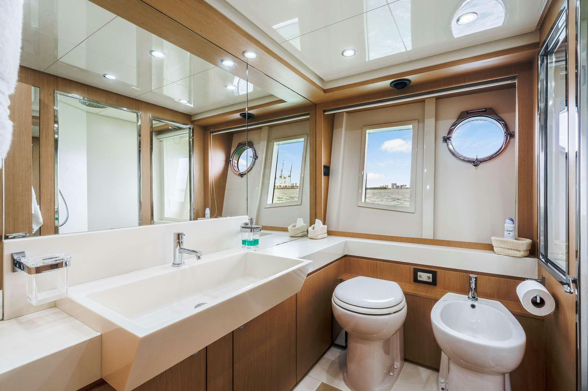 a bathroom with a sink toilet and a mirror aboard M3 Yacht for Charter