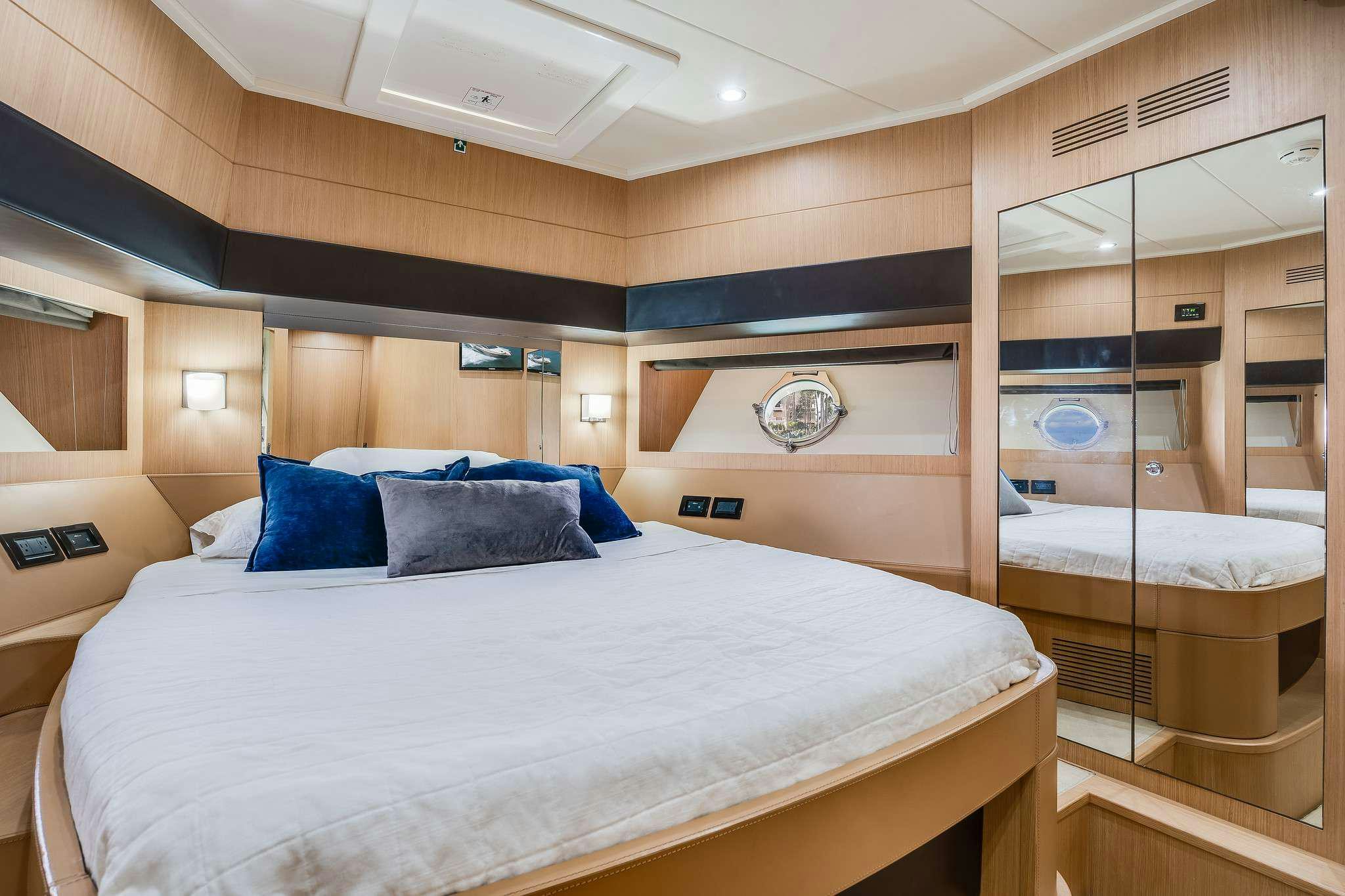 a room with a bed and a mirror aboard M3 Yacht for Charter