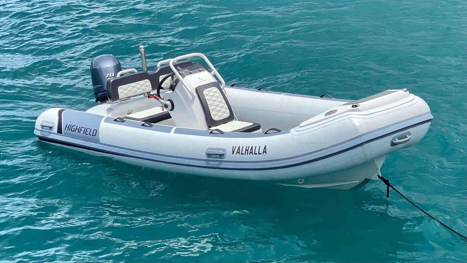 a white speed boat in the water aboard ROYAL RITA Yacht for Charter