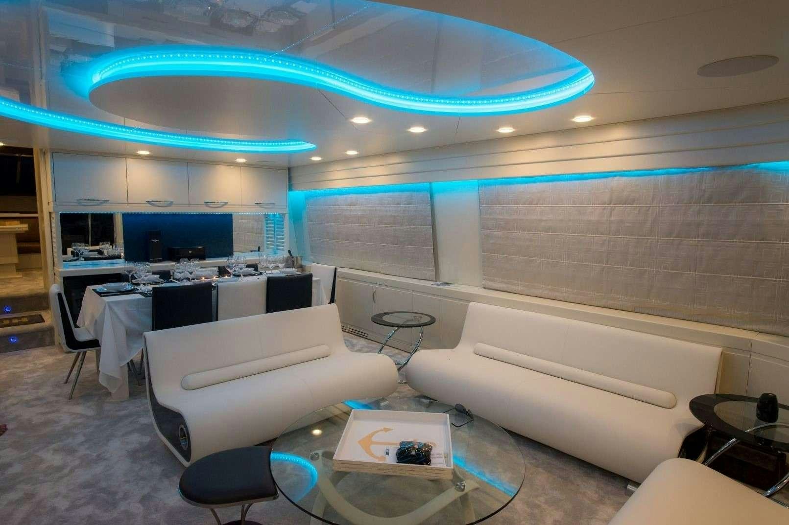 a room with a large white table and chairs aboard ANDROMEDA Yacht for Charter