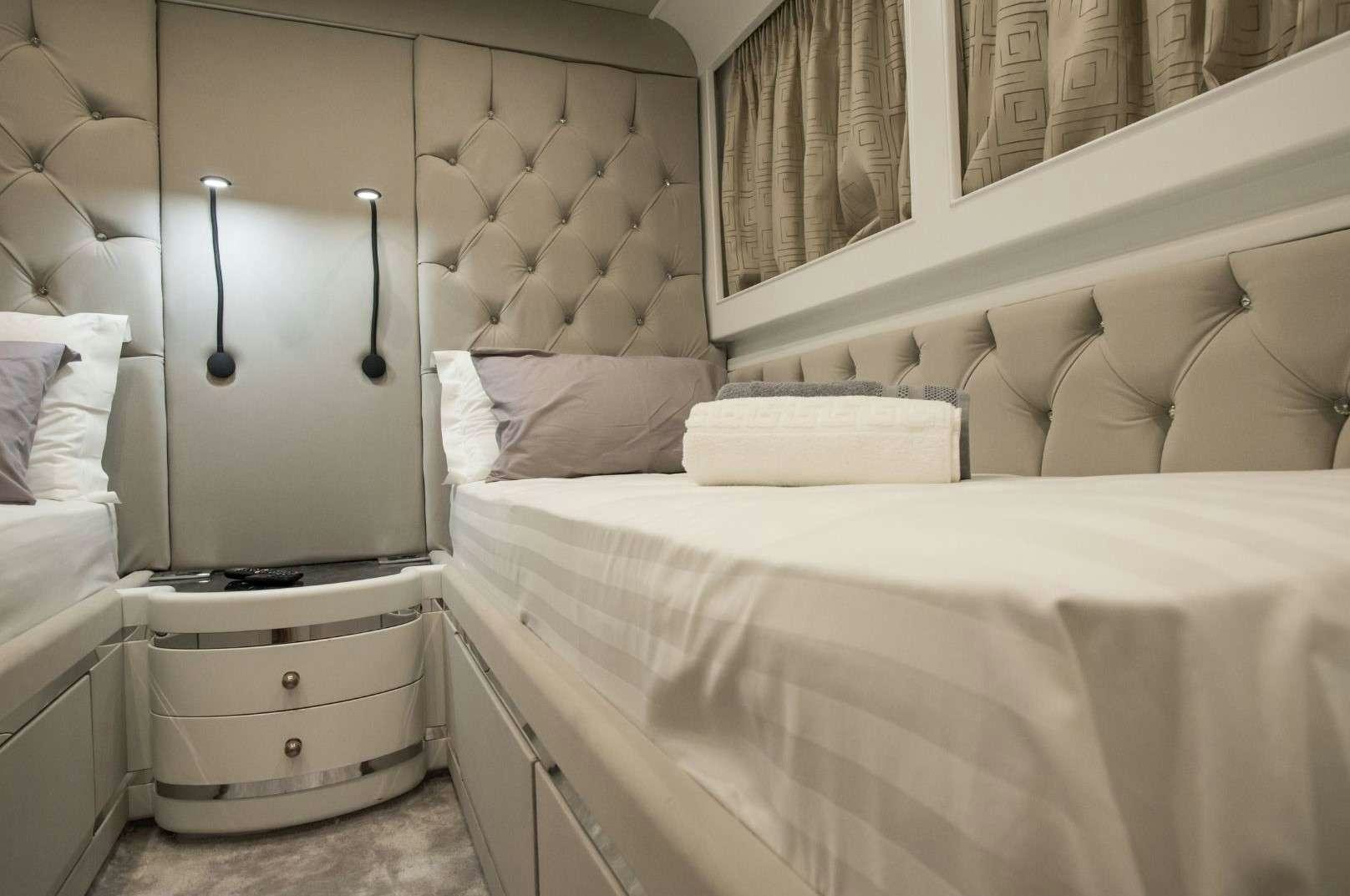 a room with a bed and a mirror aboard ANDROMEDA Yacht for Charter
