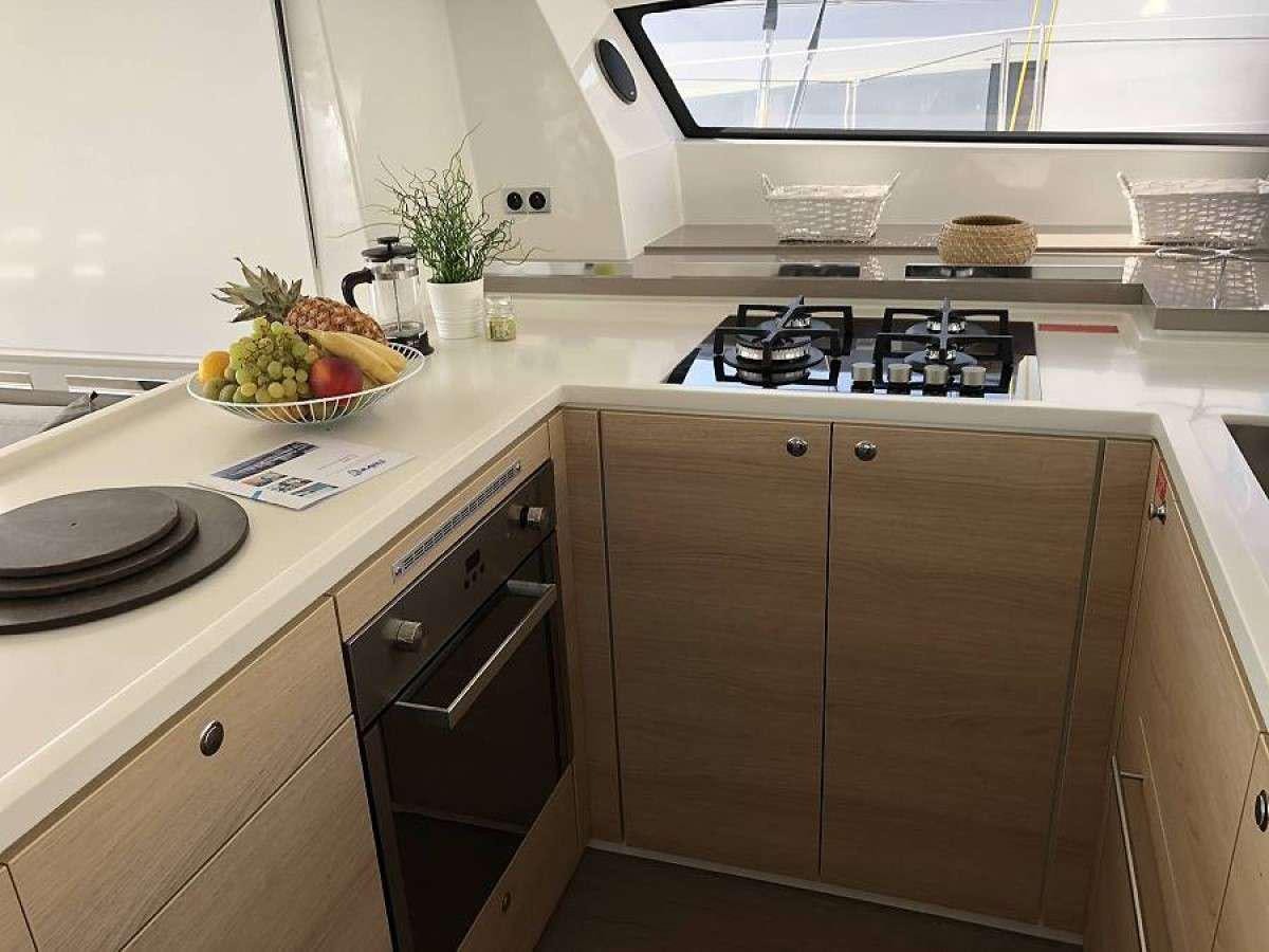 a kitchen with a bowl of fruit aboard Kos 54.Cat (Athens) Yacht for Charter