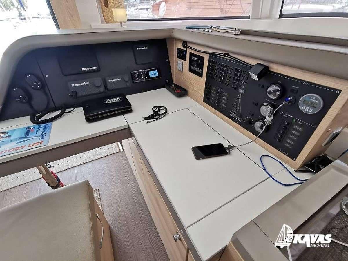 a desk with a computer and other electronics on it aboard Kos 54.Cat (Athens) Yacht for Charter