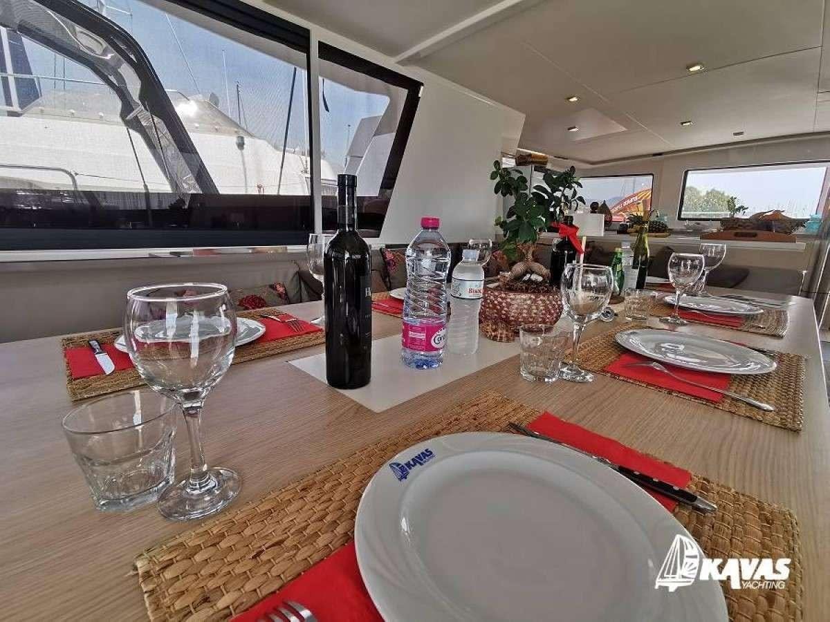 a table with food and drinks aboard Kos 54.Cat (Athens) Yacht for Charter