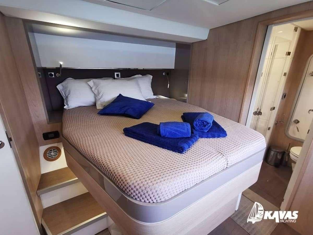 a bed in a room aboard Kos 54.Cat (Athens) Yacht for Charter