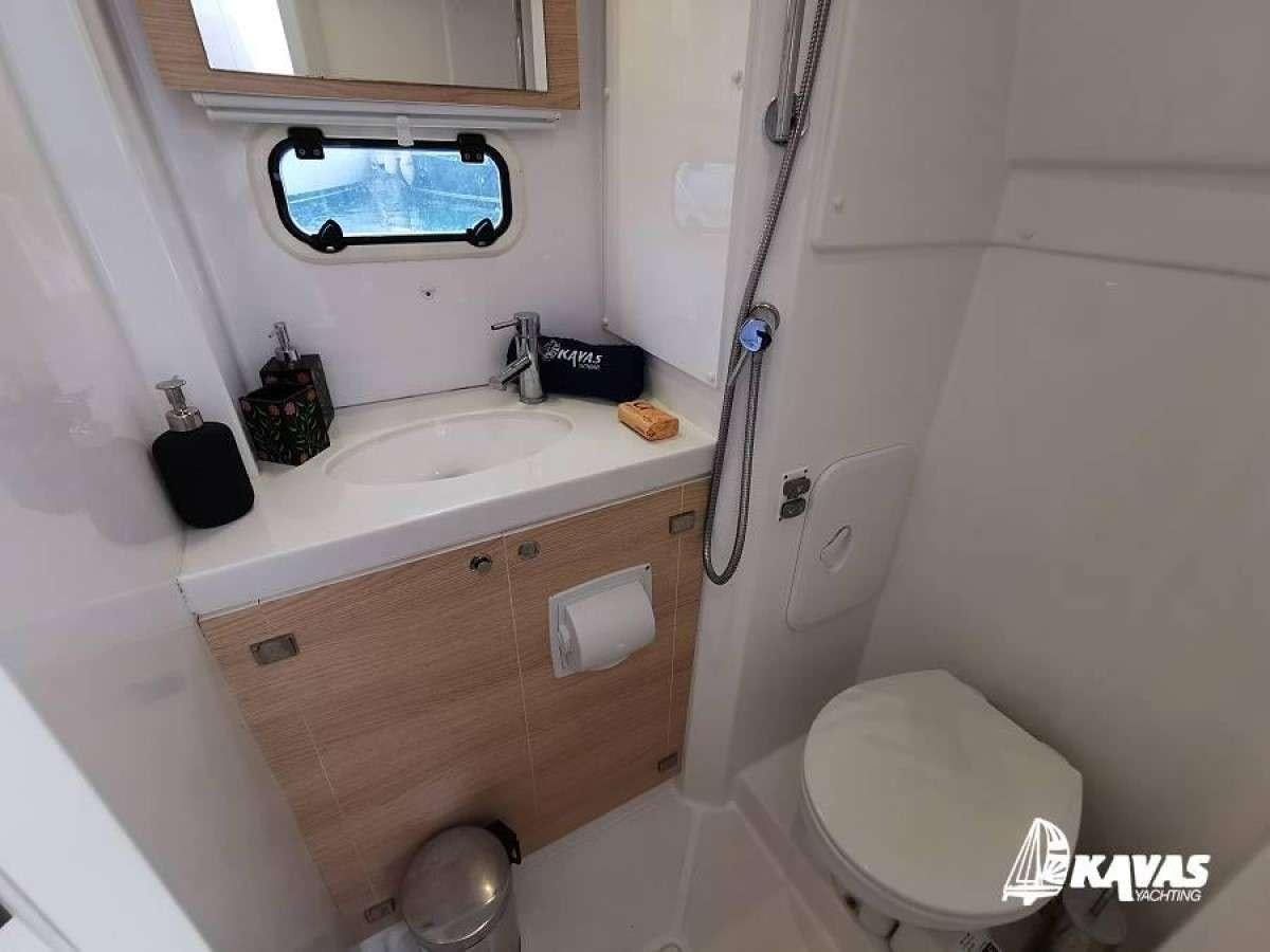 a bathroom with a sink and toilet aboard Kos 54.Cat (Athens) Yacht for Charter