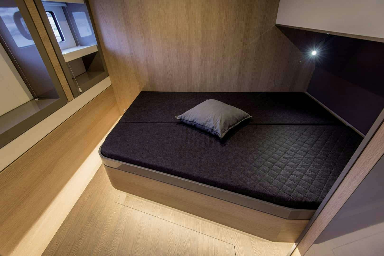 a bed in a room aboard Kos 54.Cat (Athens) Yacht for Charter