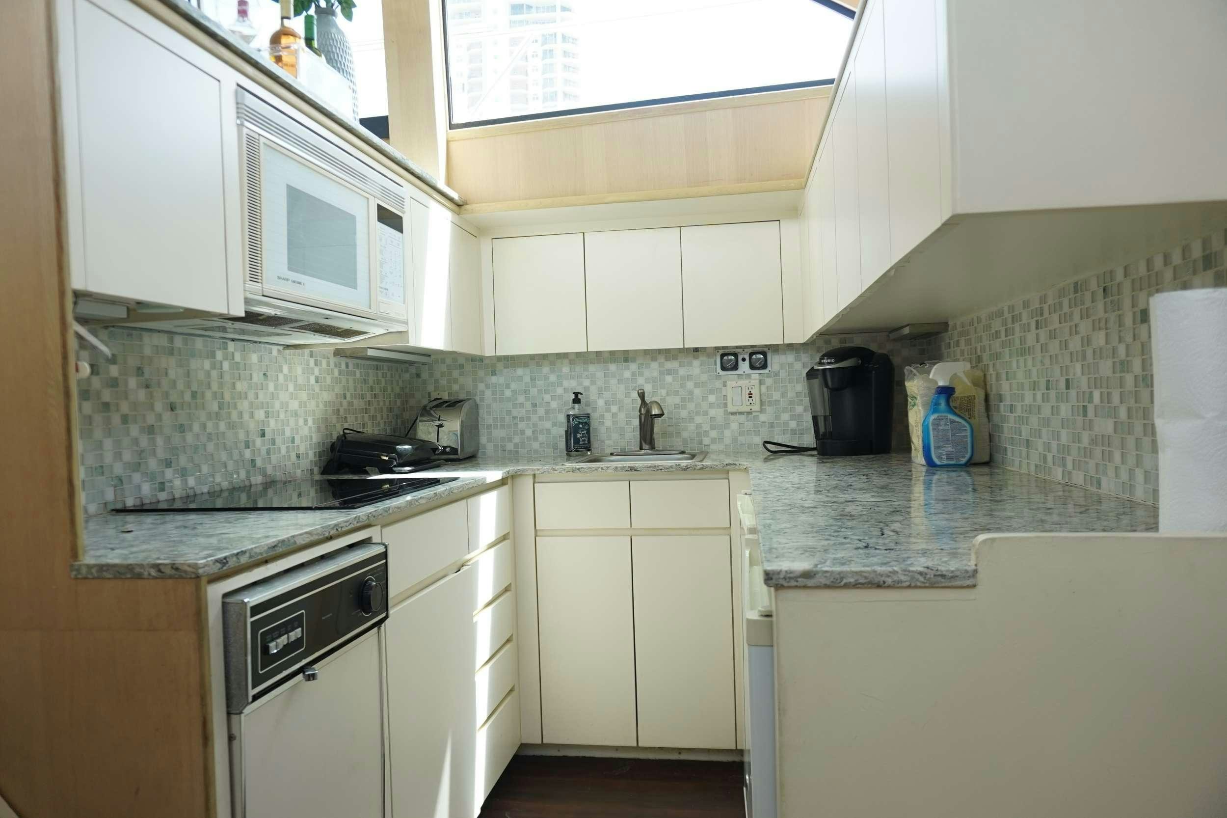 a kitchen with white cabinets aboard DIVINE Yacht for Charter