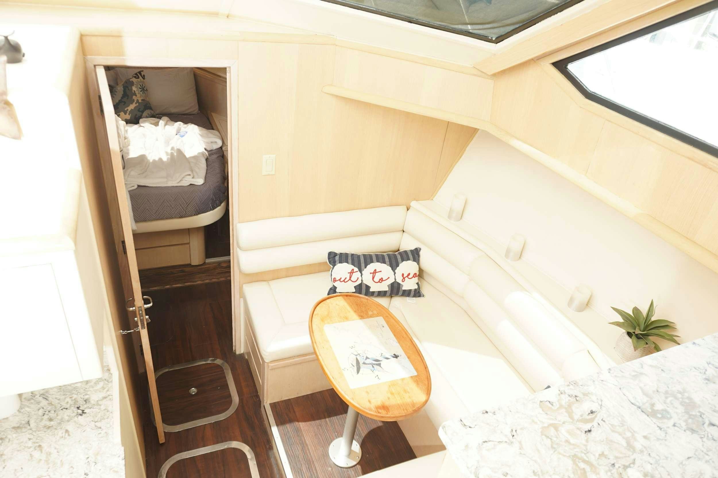 a small room with a table and chairs aboard DIVINE Yacht for Charter