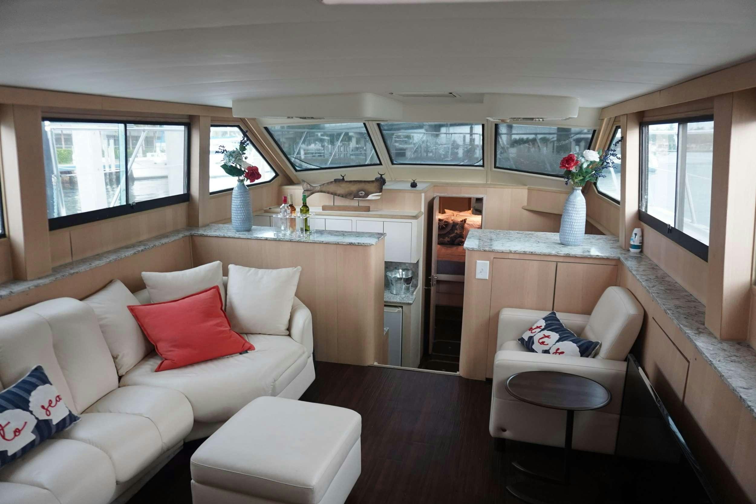 a living room with a couch and a table aboard DIVINE Yacht for Charter