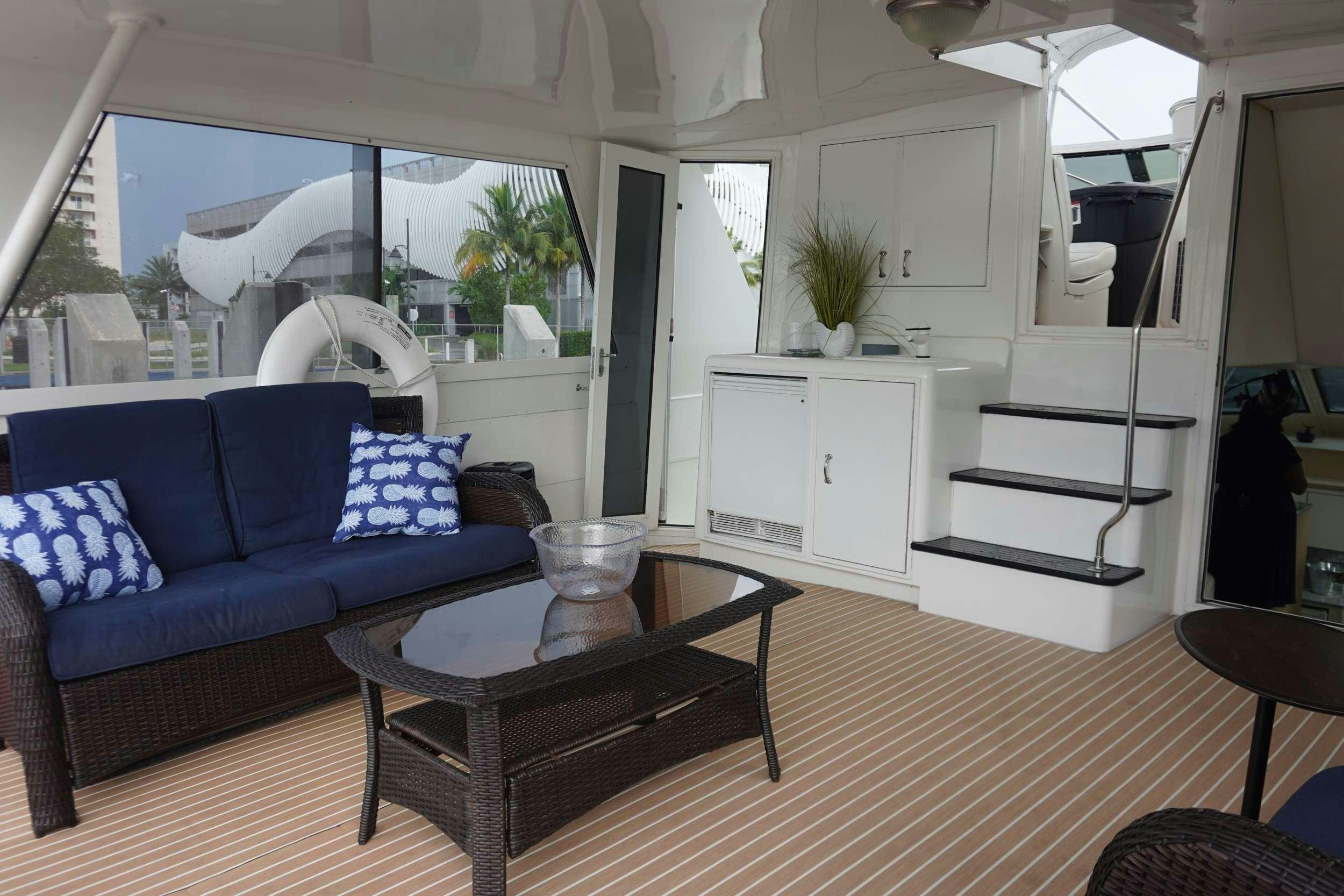 a living room with a couch and a coffee table aboard DIVINE Yacht for Charter