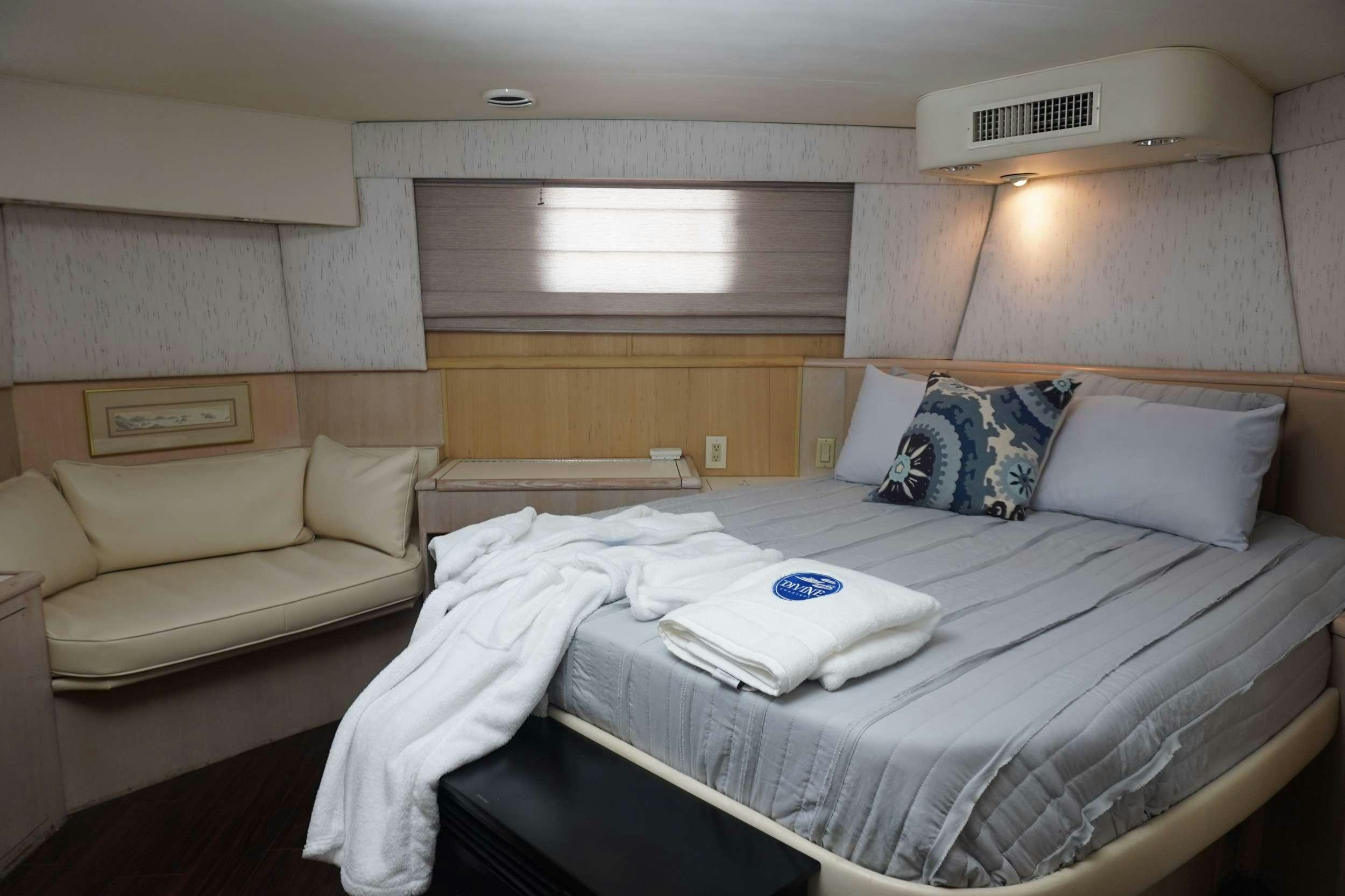 a room with beds and a couch aboard DIVINE Yacht for Charter