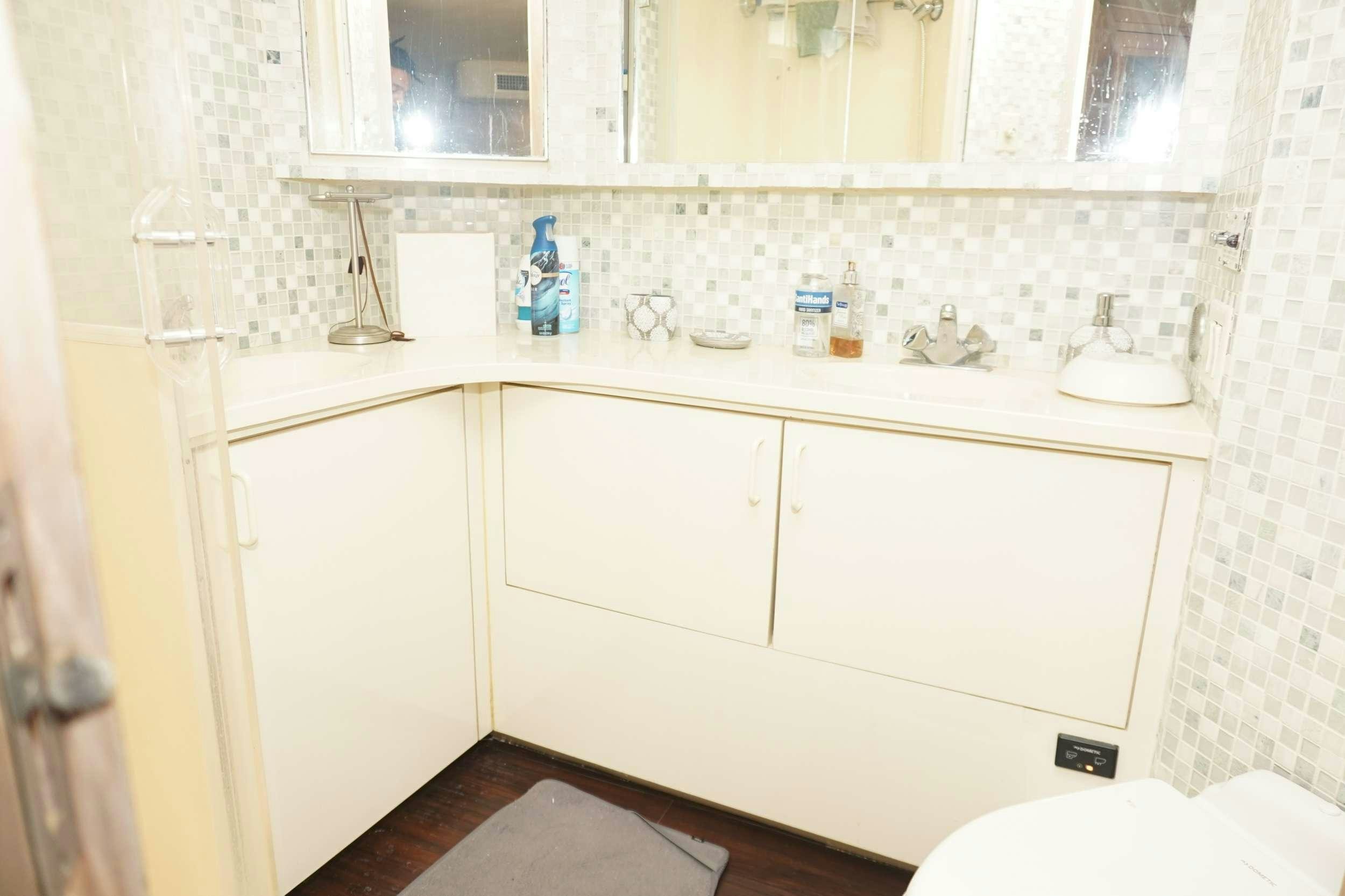 a bathroom with a sink and cabinets aboard DIVINE Yacht for Charter