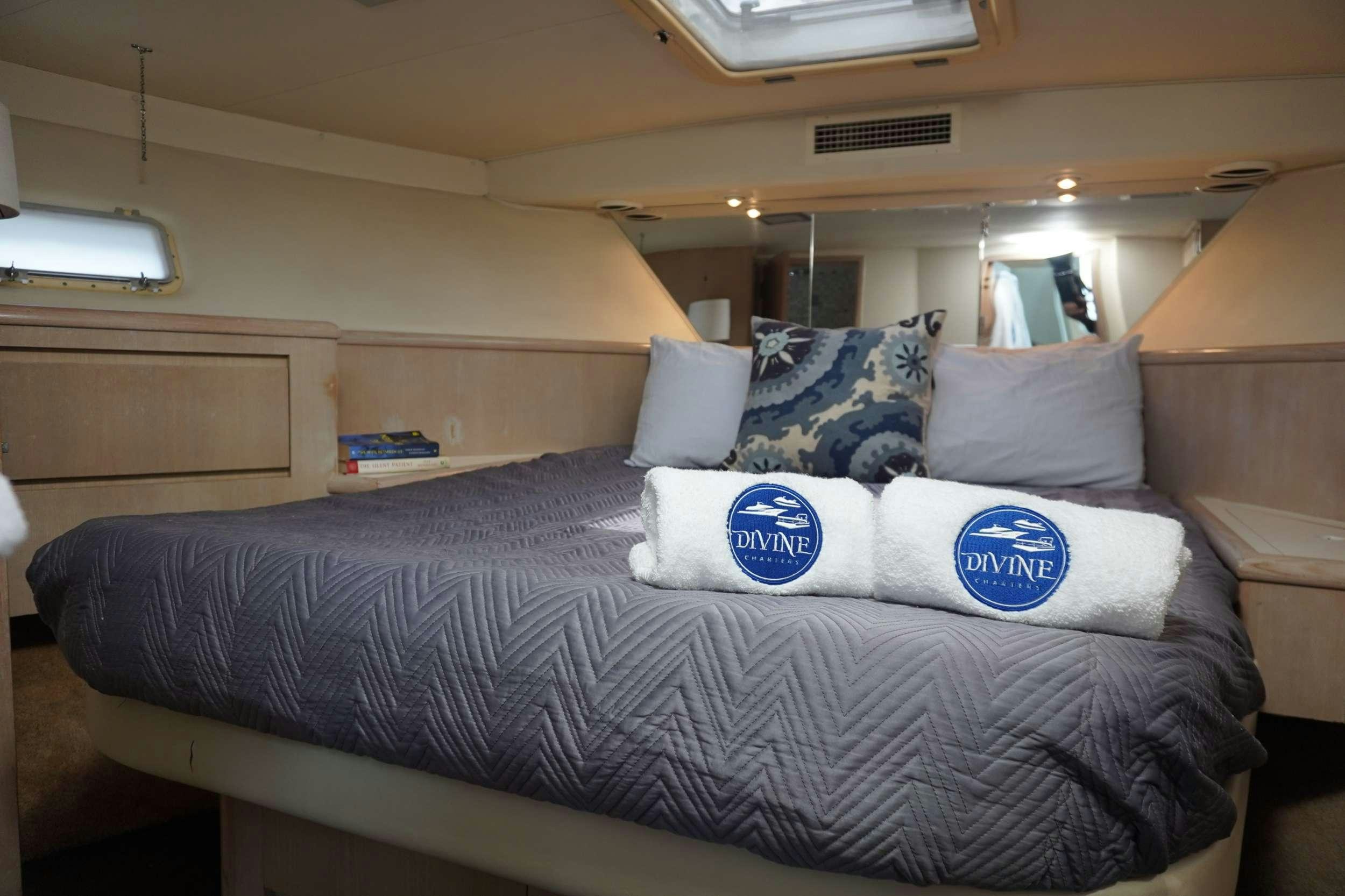a bed with pillows on it aboard DIVINE Yacht for Charter