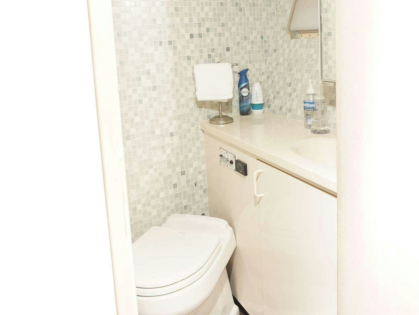 a bathroom with a toilet and a sink aboard DIVINE Yacht for Charter