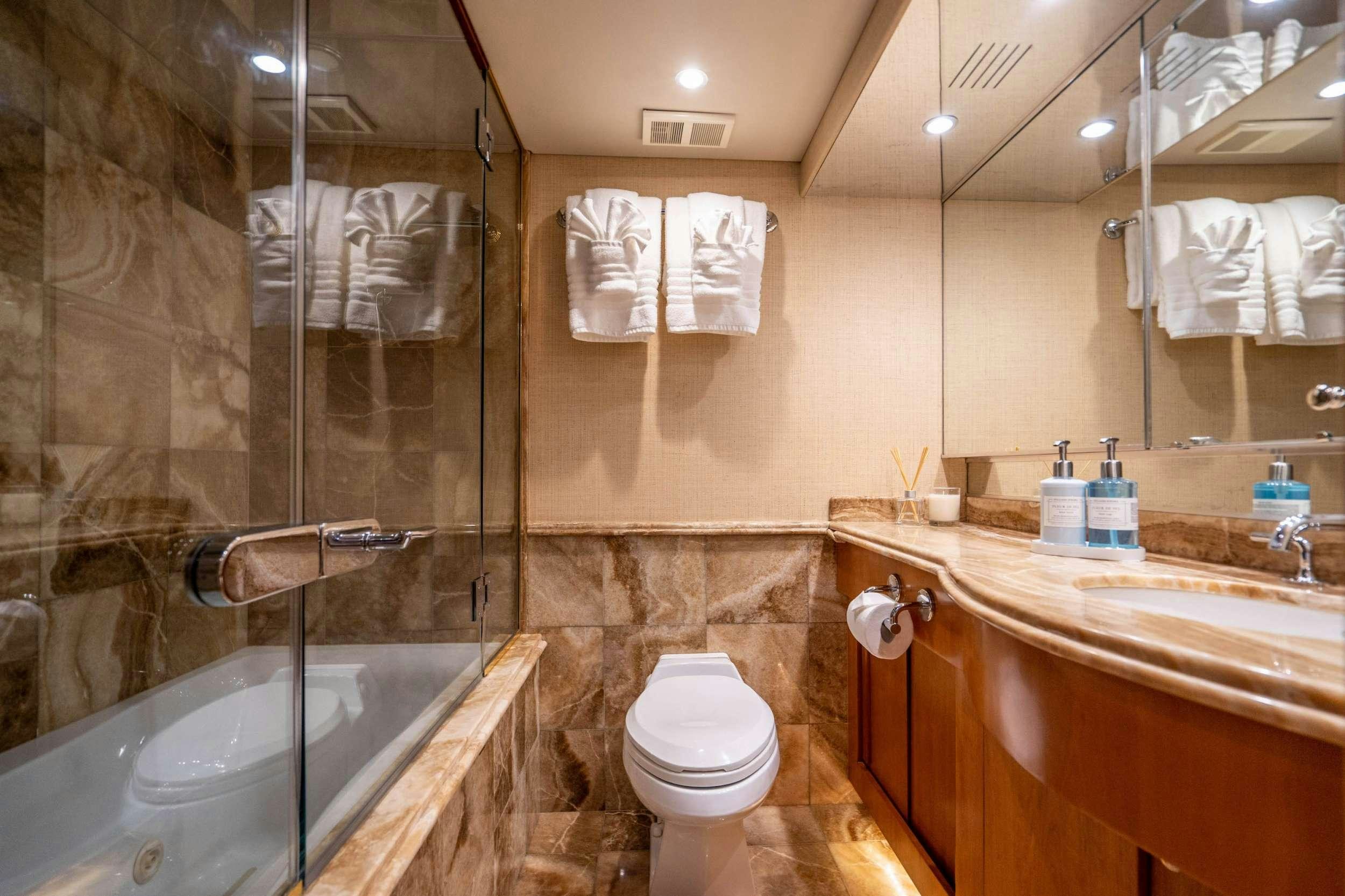 a bathroom with a glass shower aboard CENTODUE Yacht for Charter