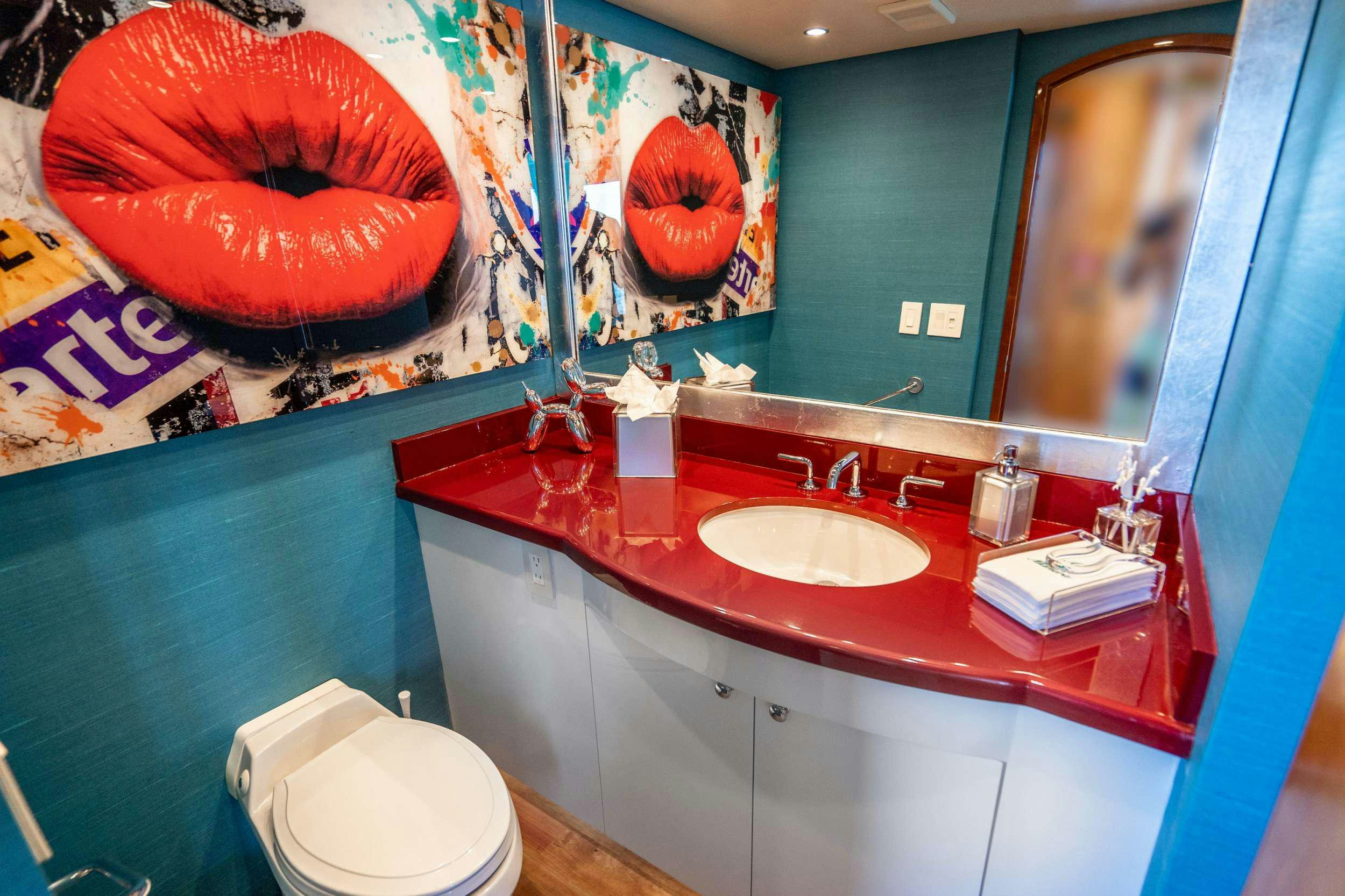 a bathroom with a countertop sink and a toilet aboard CENTODUE Yacht for Charter