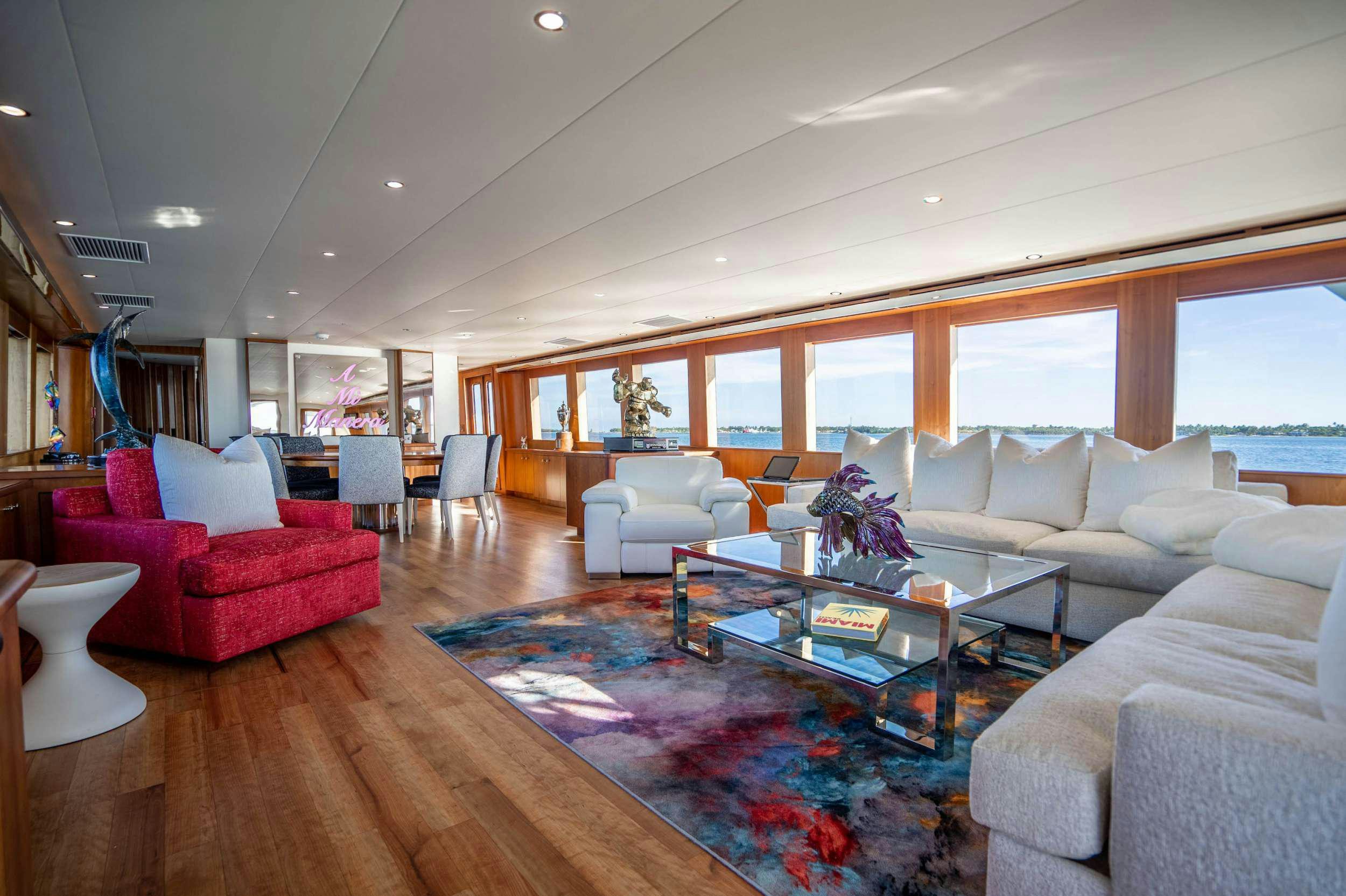 a living room with a large window aboard CENTODUE Yacht for Charter
