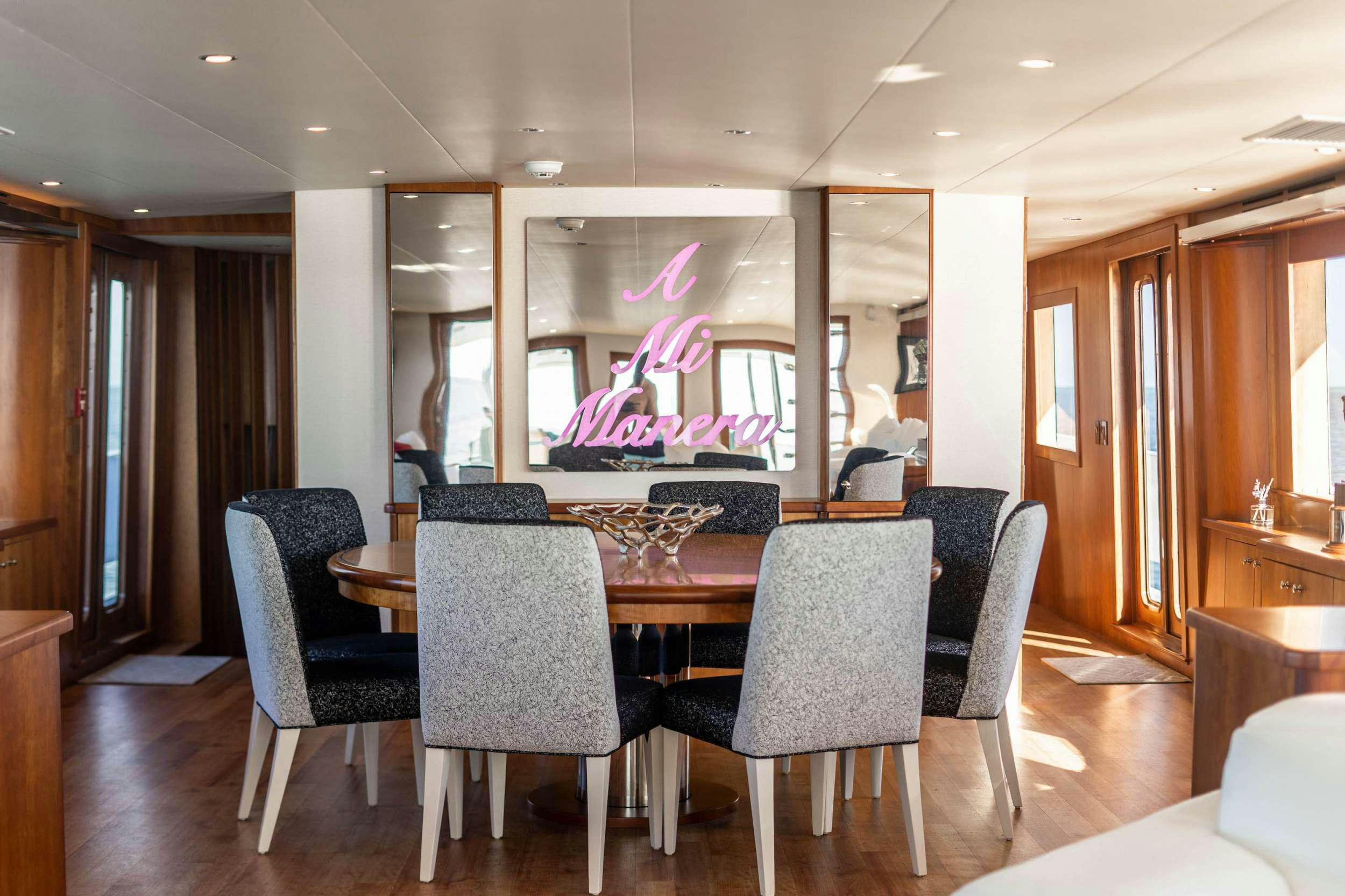 a dining room with a table and chairs aboard CENTODUE Yacht for Charter