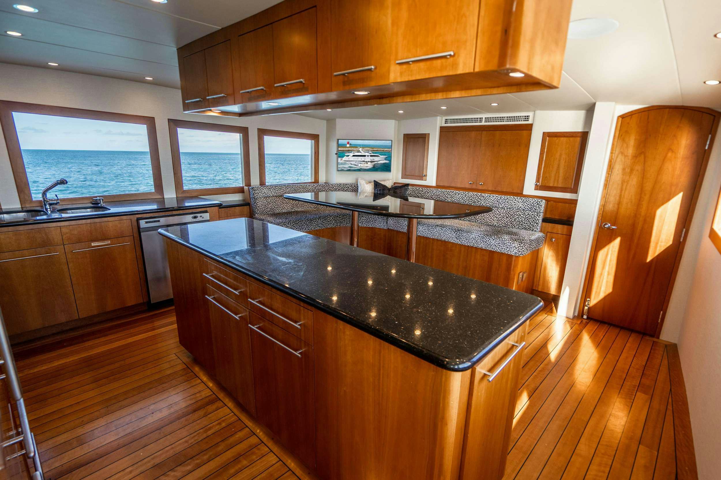 a kitchen with wooden cabinets aboard CENTODUE Yacht for Charter