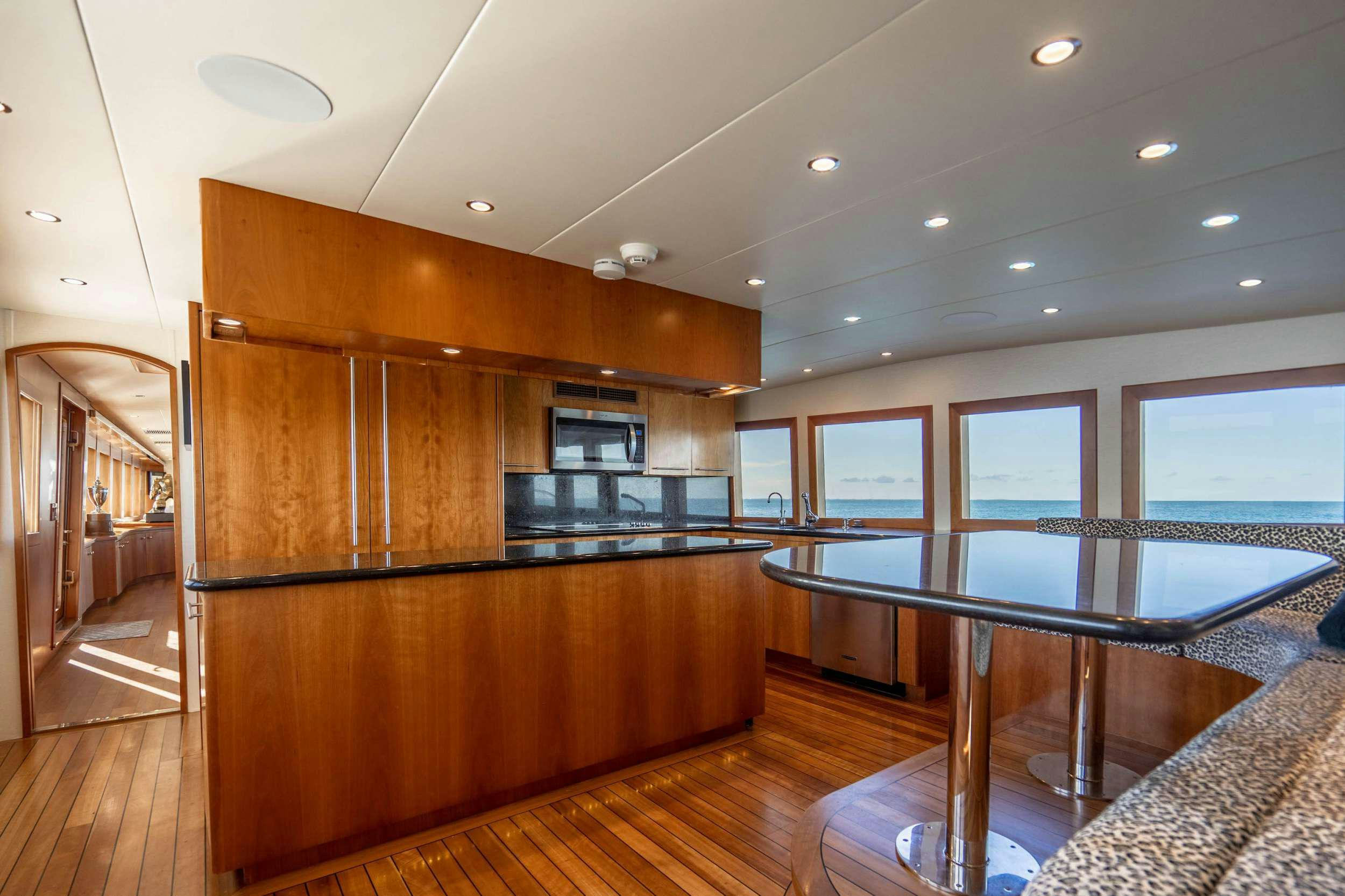 a room with a large table and chairs aboard CENTODUE Yacht for Charter