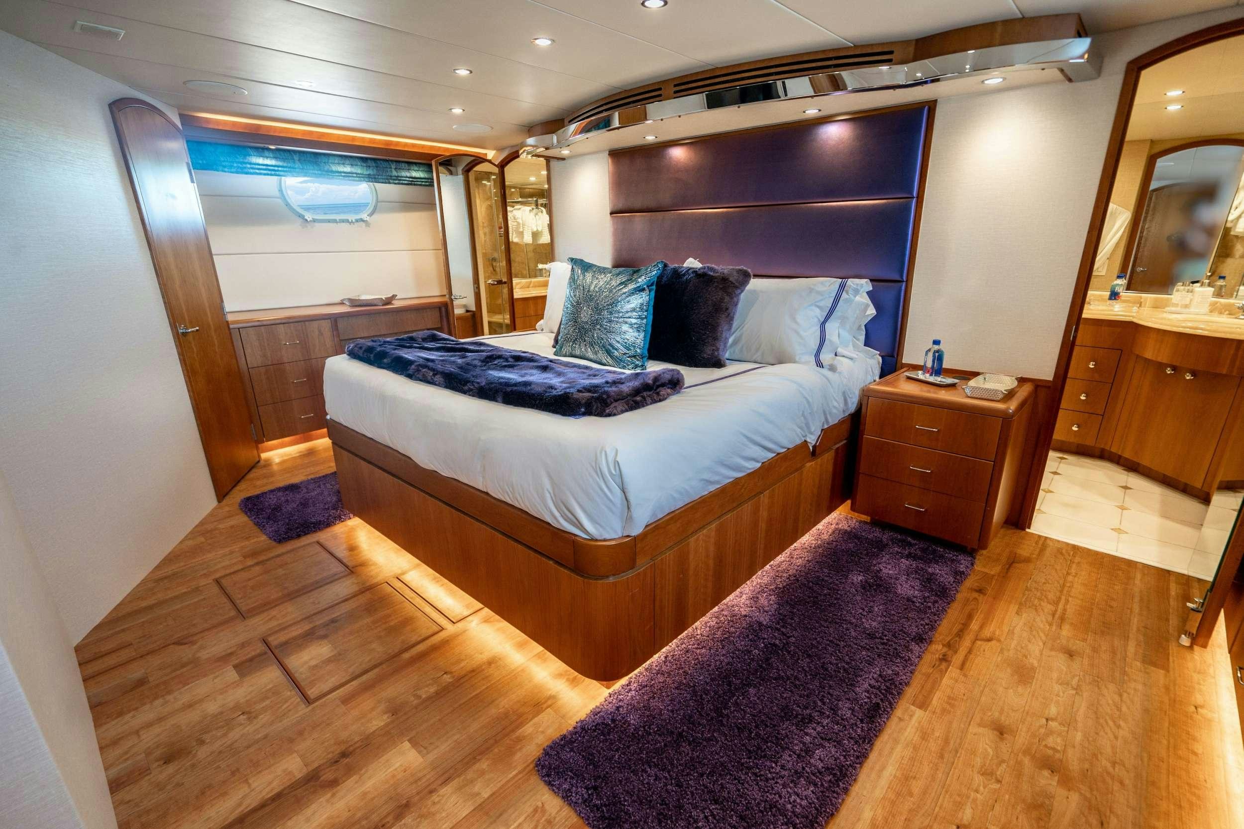 a large bed in a room aboard CENTODUE Yacht for Charter
