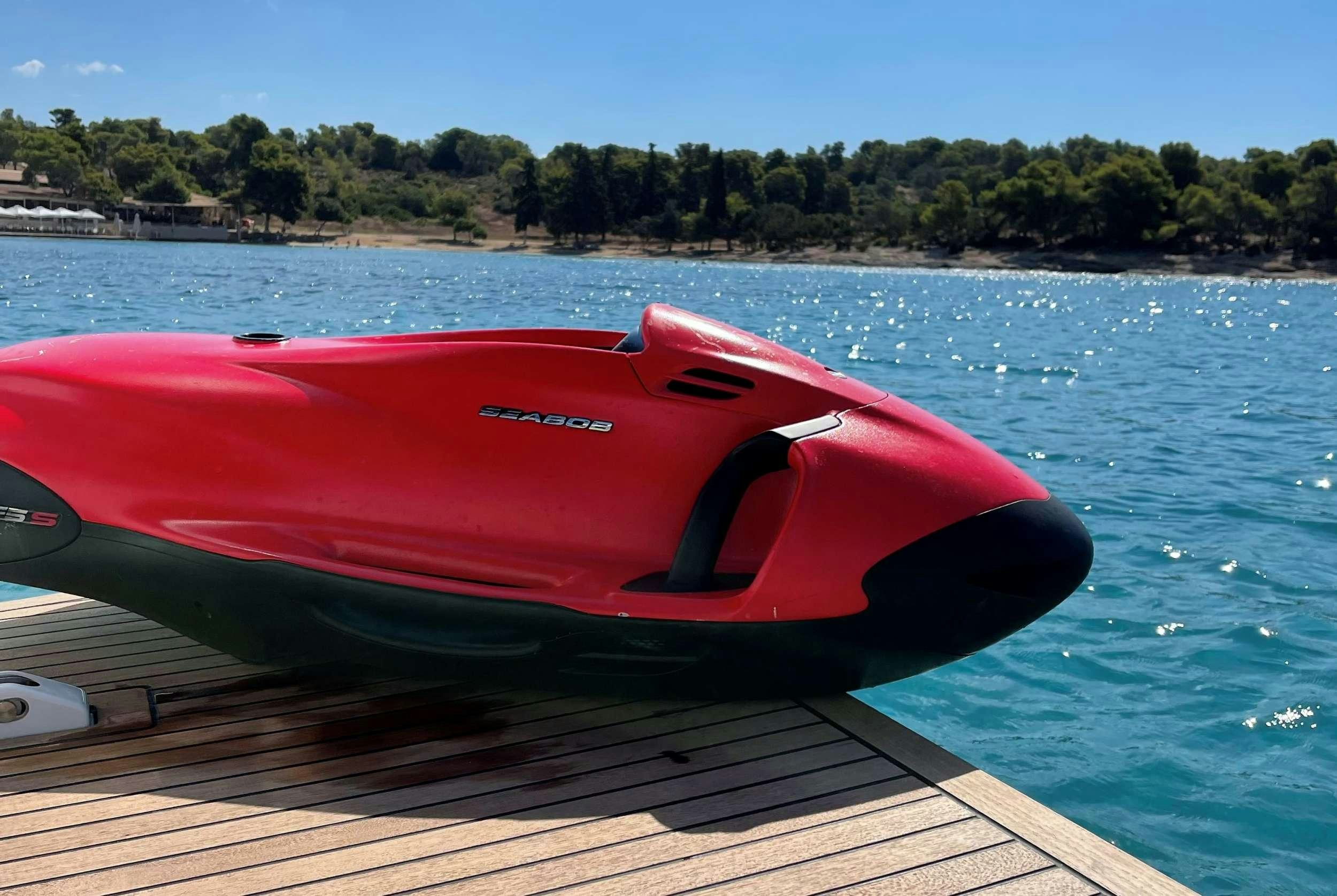 a red sports car on a dock aboard MIO SHI Yacht for Charter