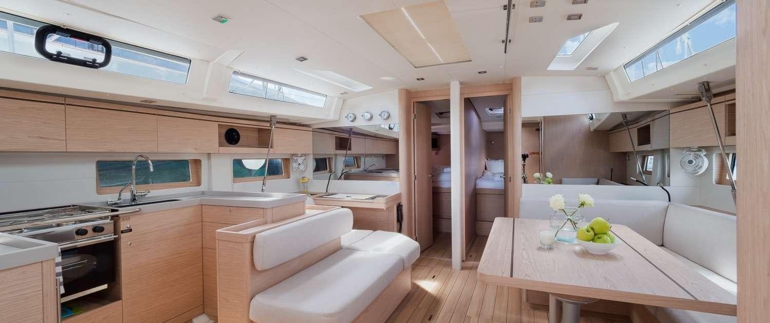 a kitchen with a table and a couch aboard MIO SHI Yacht for Charter