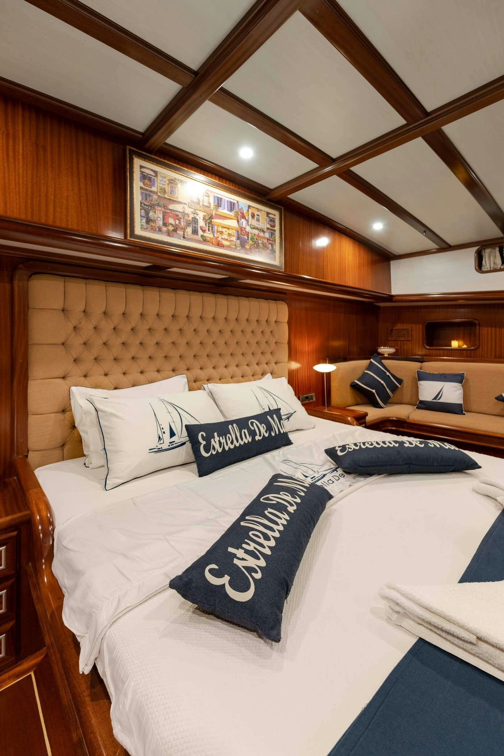a bed with white sheets and pillows aboard ESTRELLA DE MAR Yacht for Charter