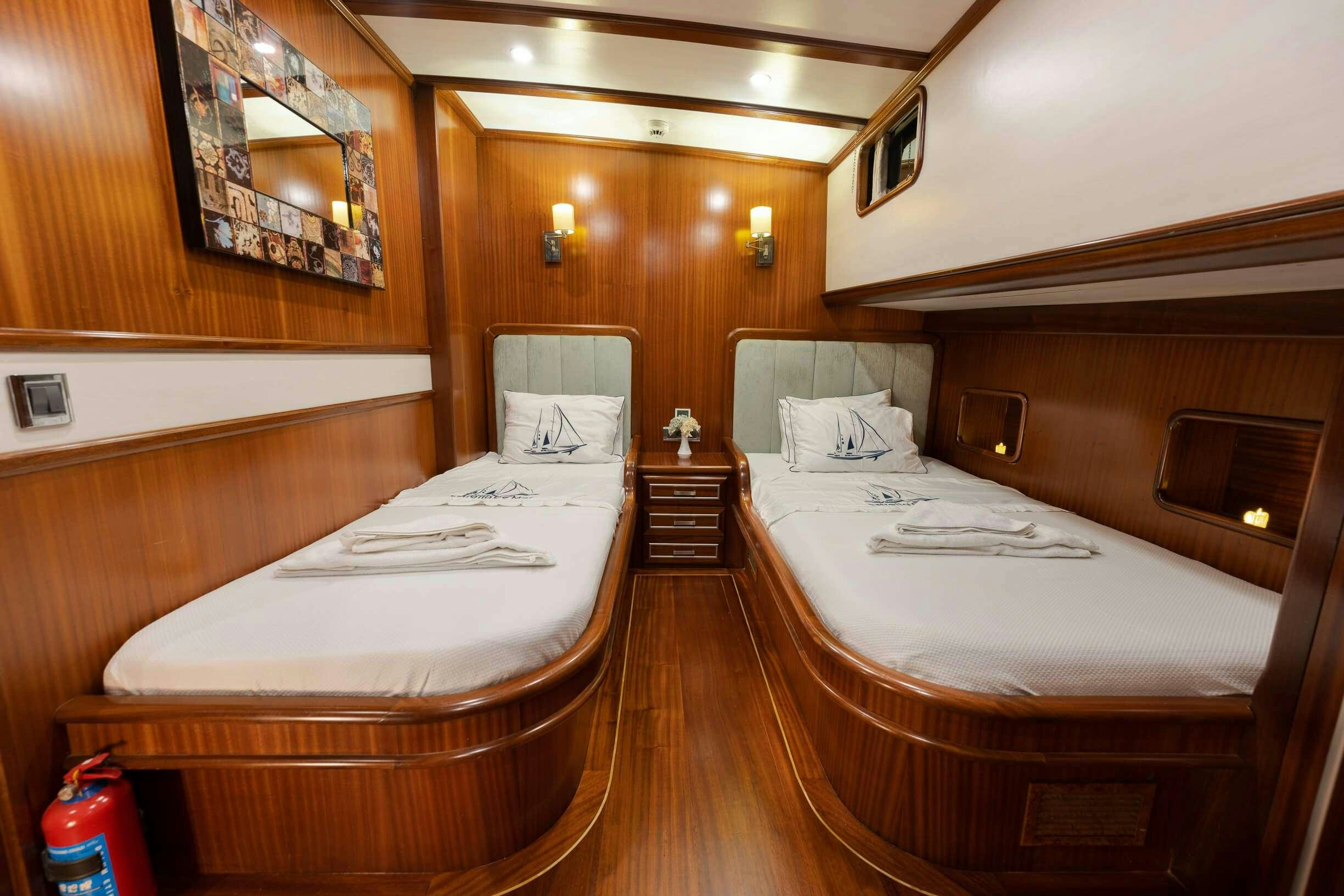 a room with two beds aboard ESTRELLA DE MAR Yacht for Charter