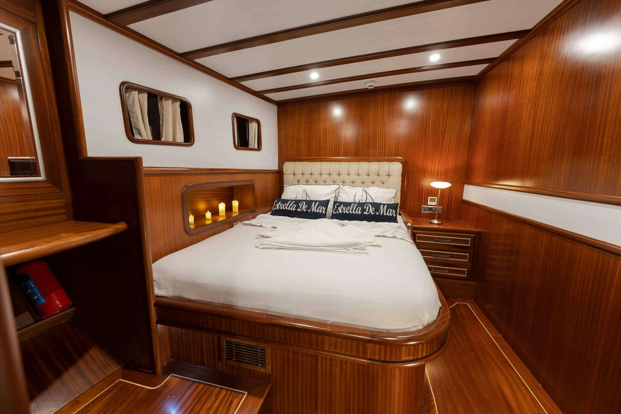 a bedroom with a bed and a television aboard ESTRELLA DE MAR Yacht for Charter
