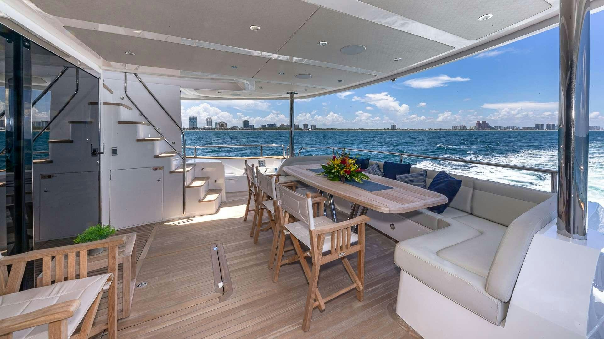 a room with a table and chairs aboard MIRRACLE Yacht for Charter