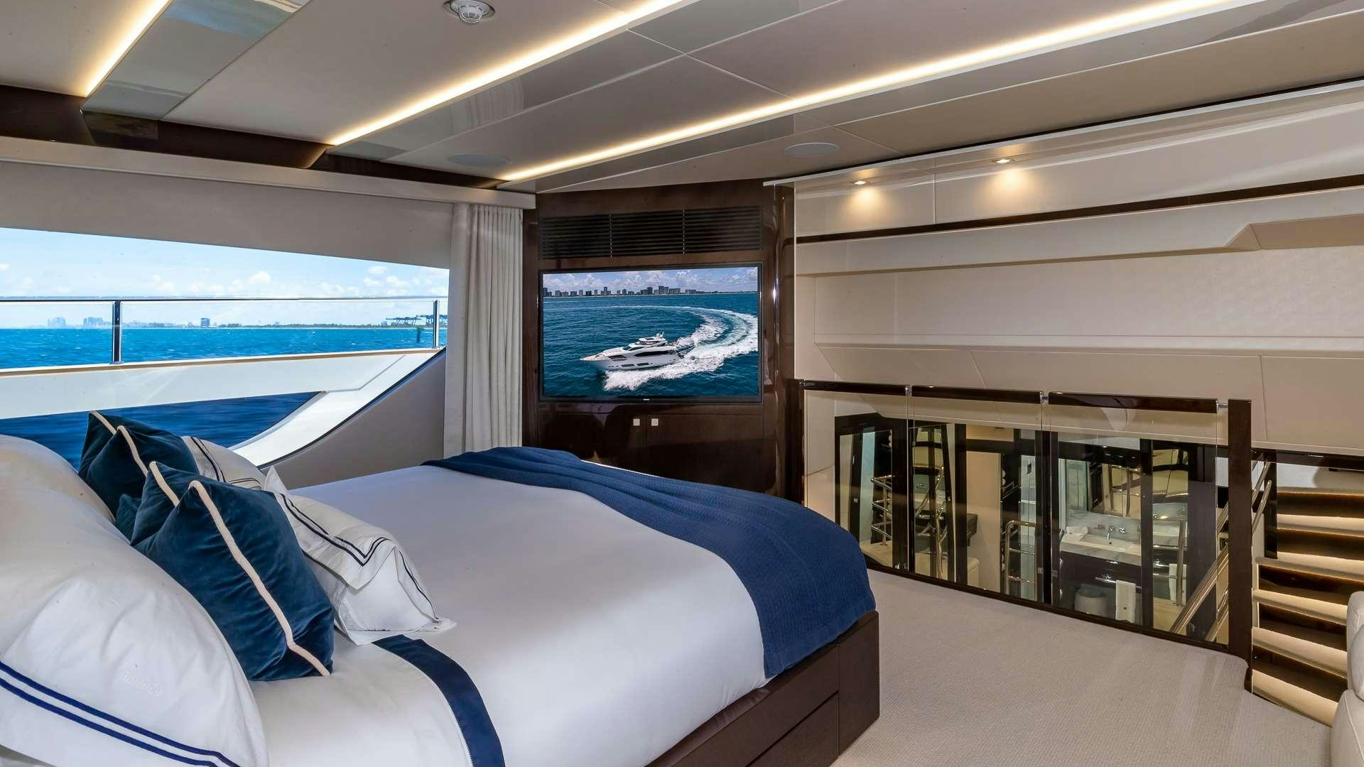 a room with a bed and a television aboard MIRRACLE Yacht for Charter