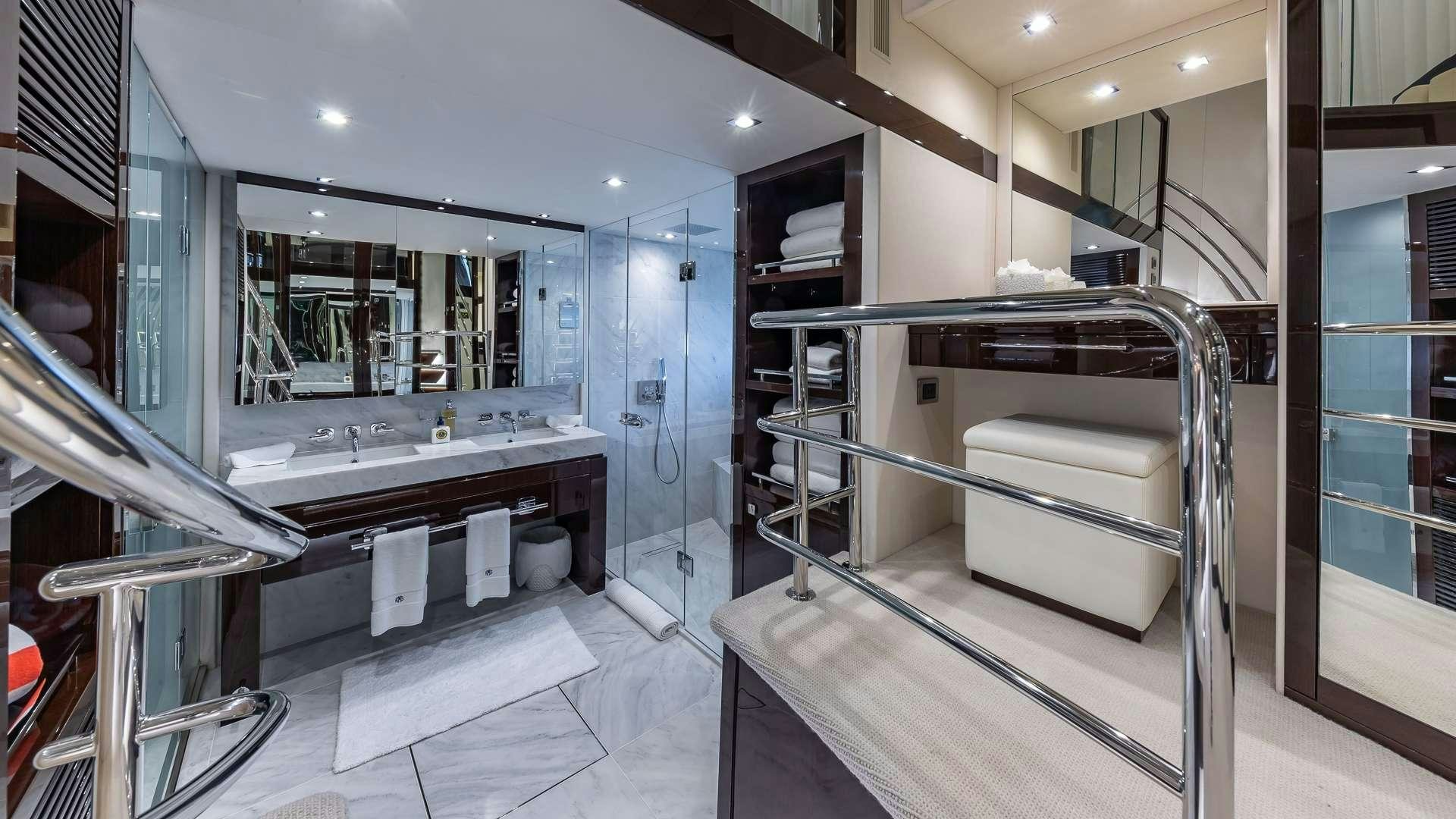 a bathroom with a large mirror aboard MIRRACLE Yacht for Charter
