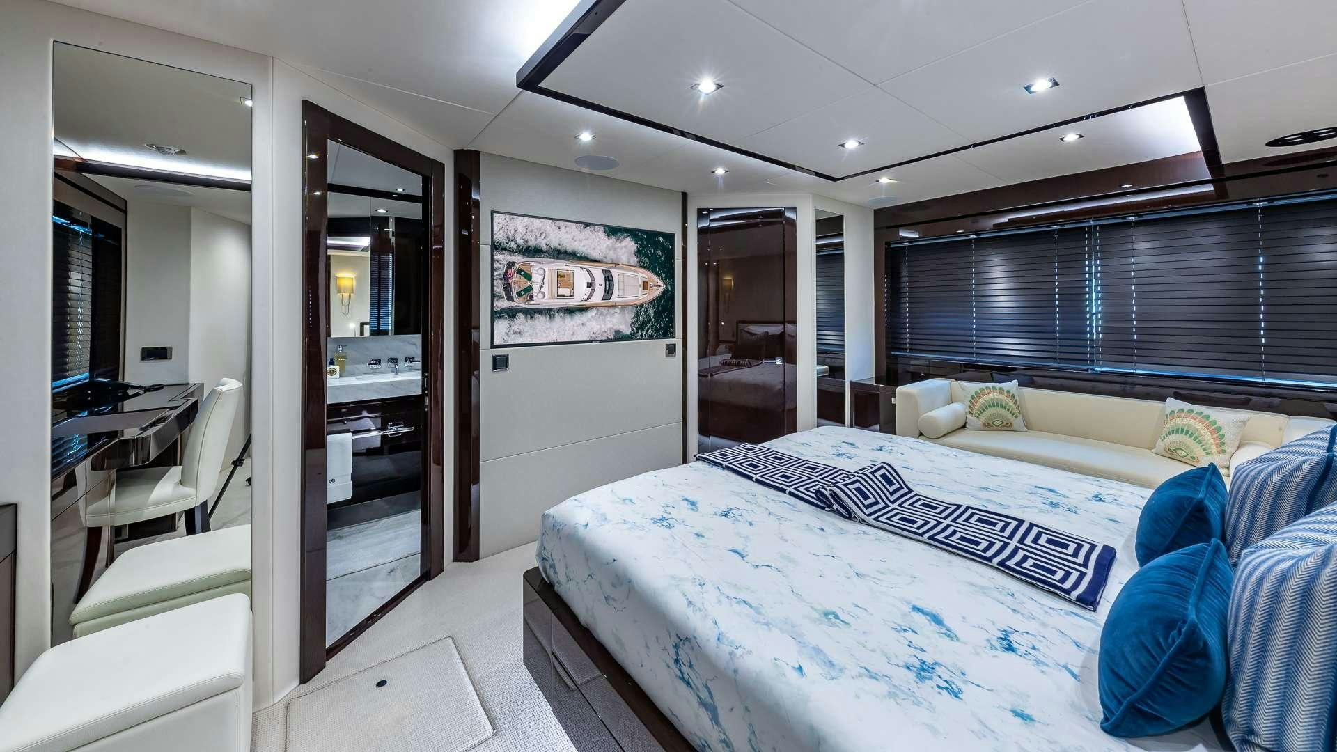 a bedroom with a bed and a large mirror aboard MIRRACLE Yacht for Charter
