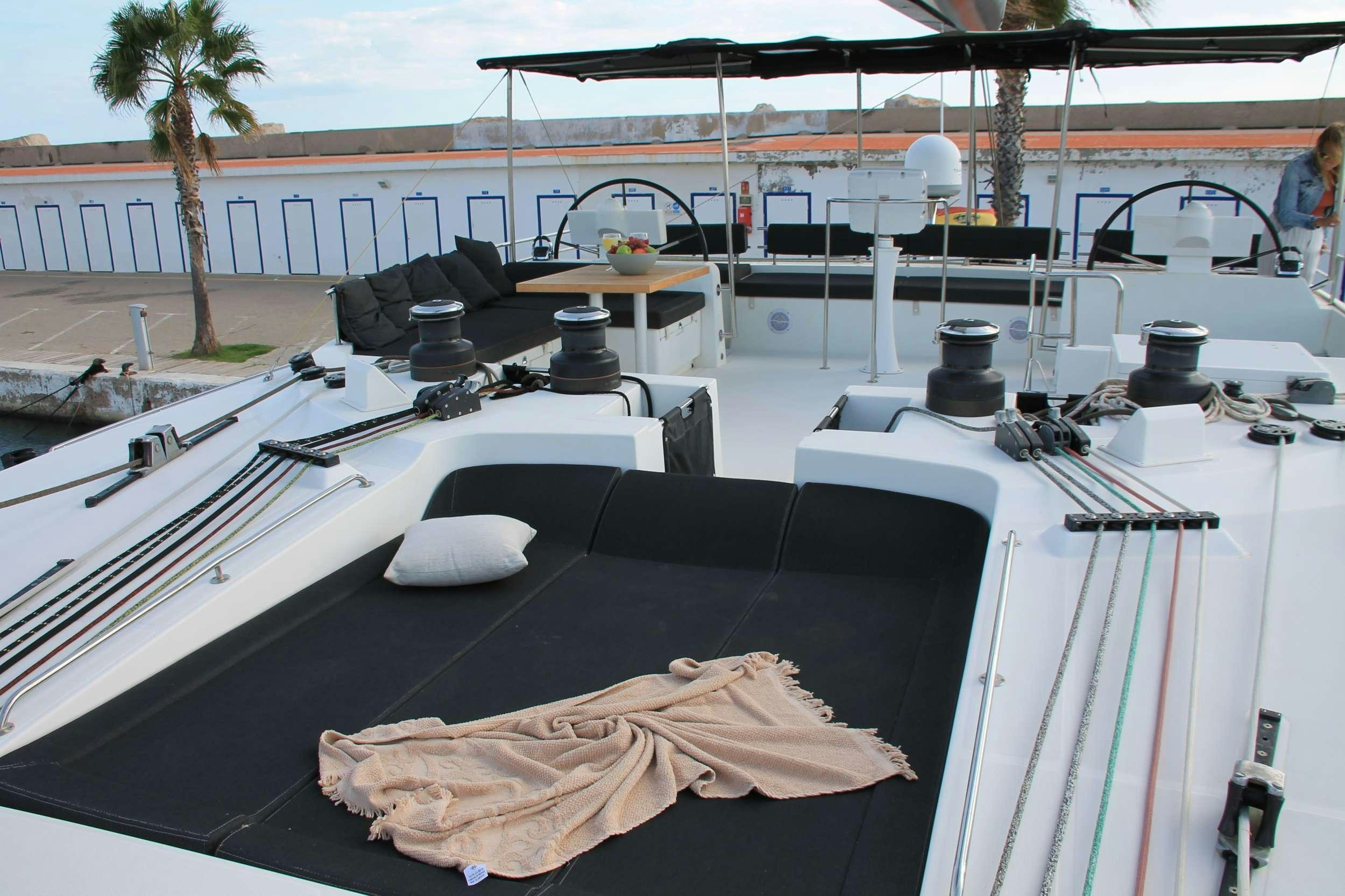 a large white boat with a black surface and a black surface with a white surface and black and aboard JARANA Yacht for Charter