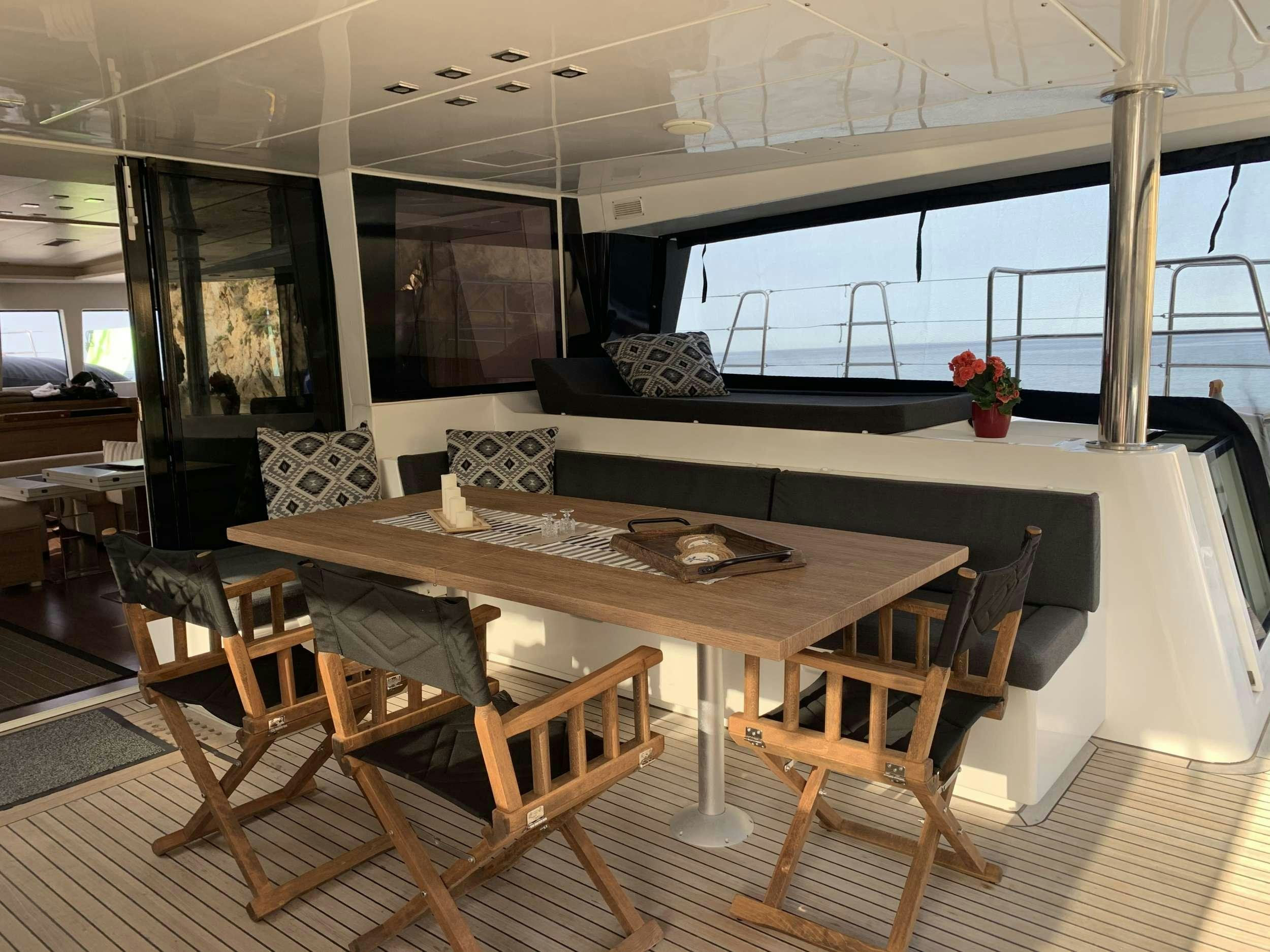 a dining table on a deck aboard JARANA Yacht for Charter