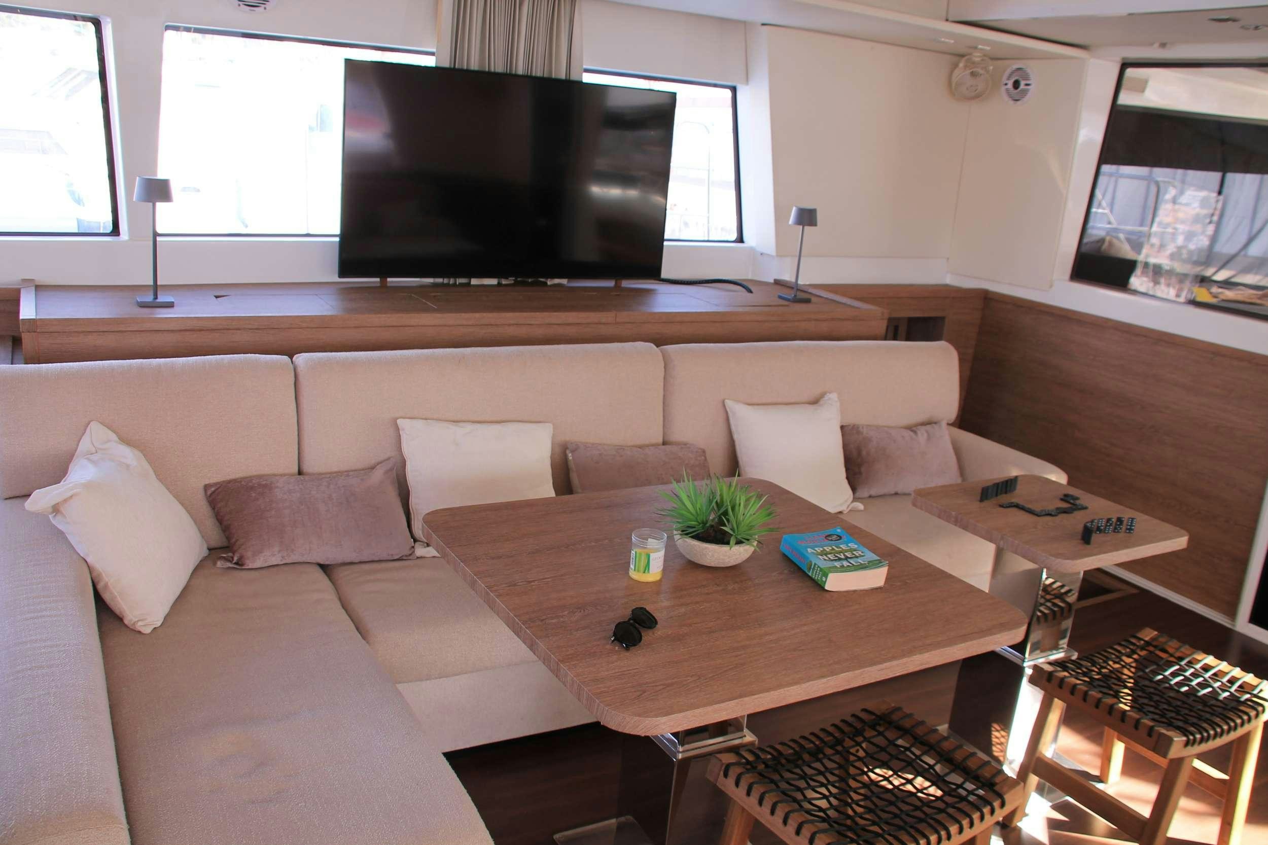 a living room with a couch and a television aboard JARANA Yacht for Charter