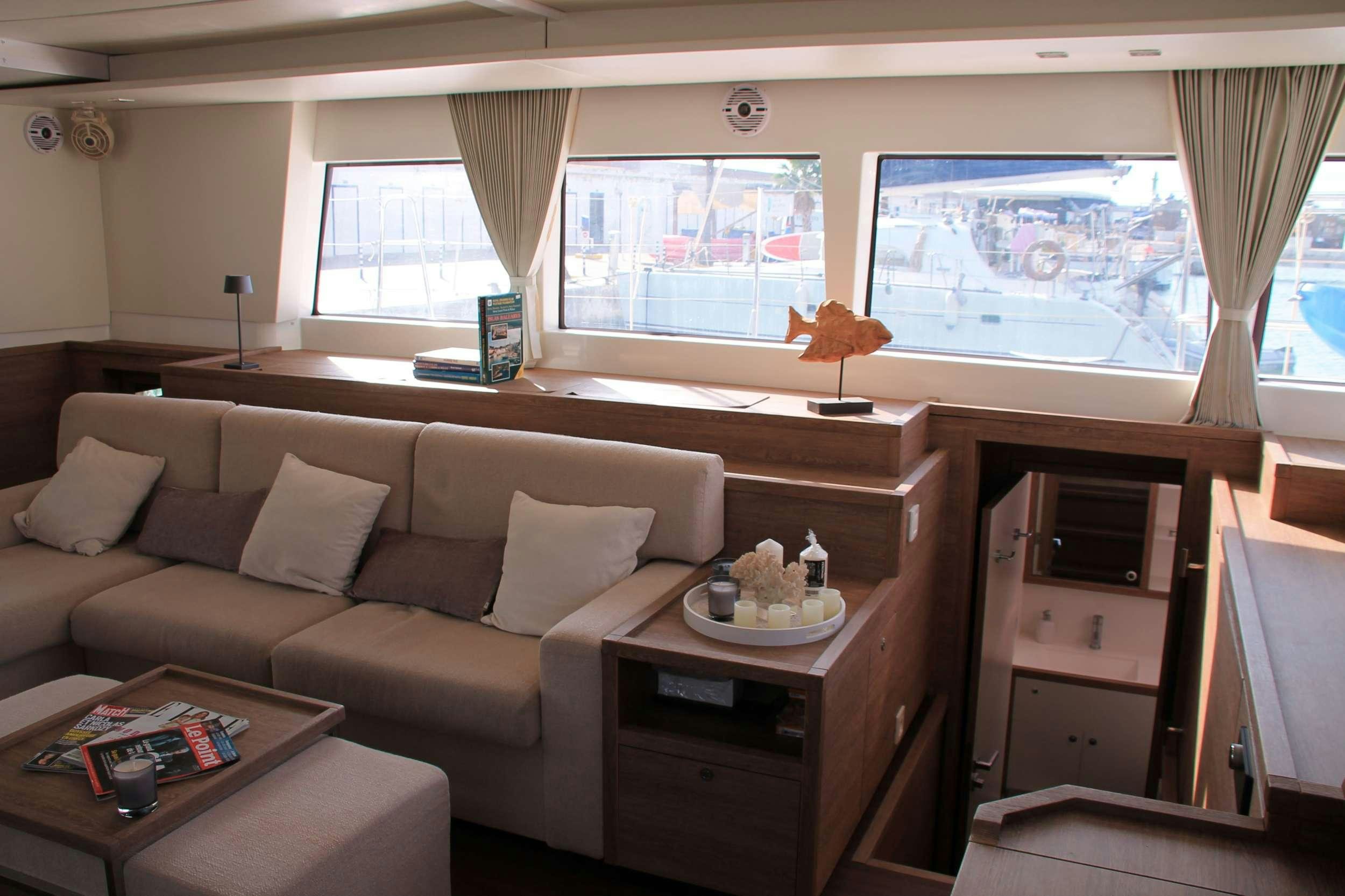 a living room with a couch and a coffee table aboard JARANA Yacht for Charter