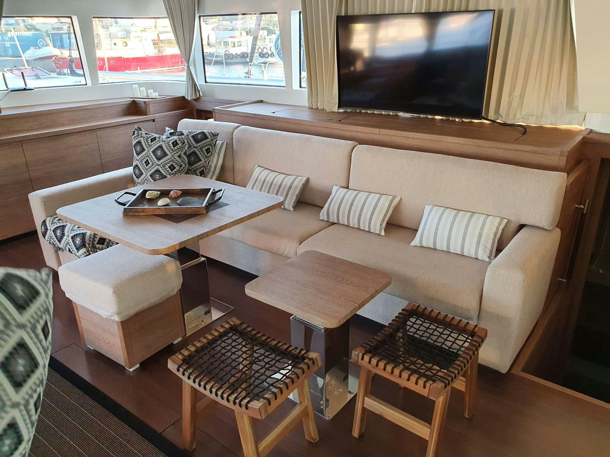 a living room with a couch and a coffee table aboard JARANA Yacht for Charter