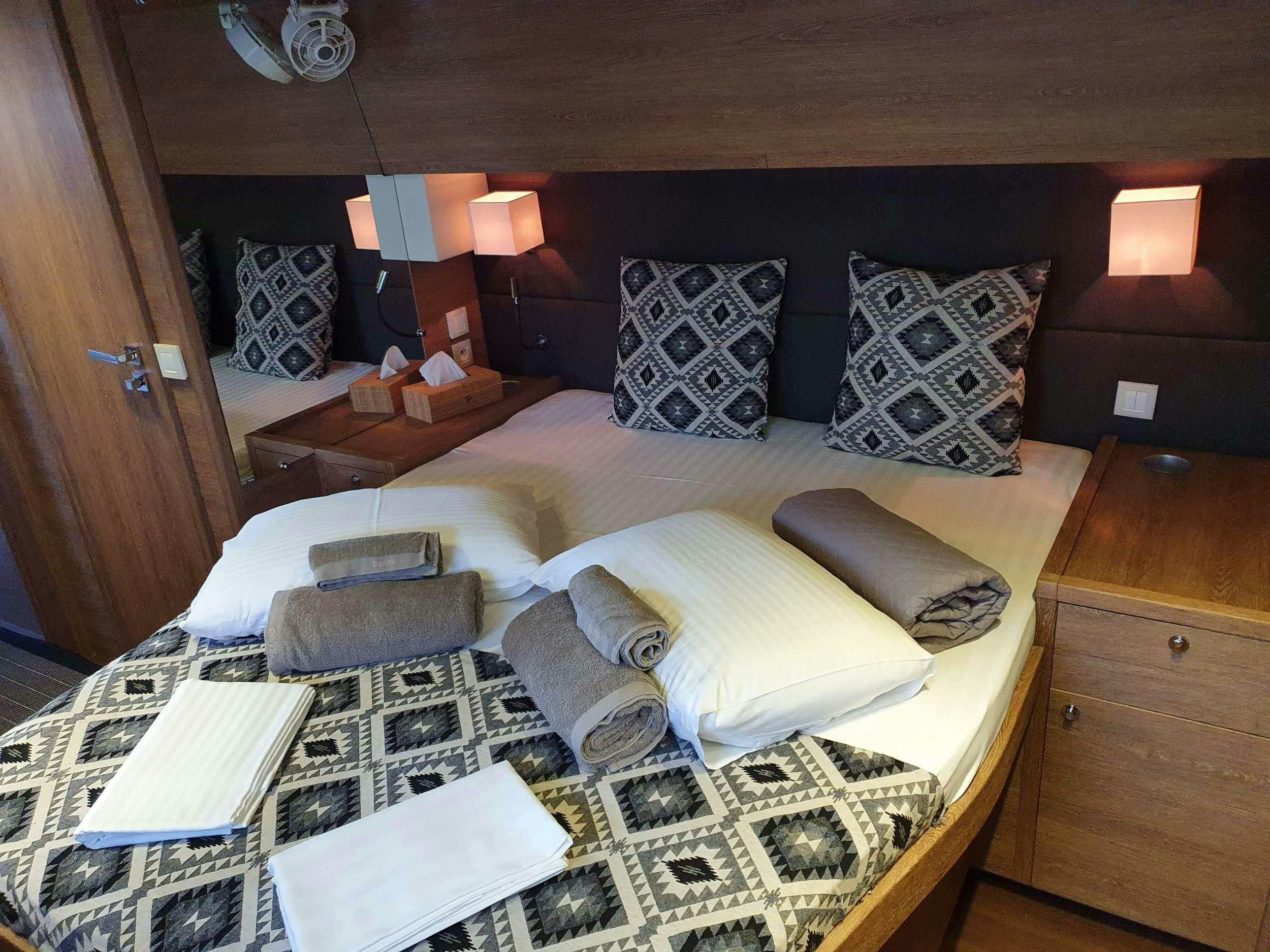 a bed with a pillow and pillows aboard JARANA Yacht for Charter