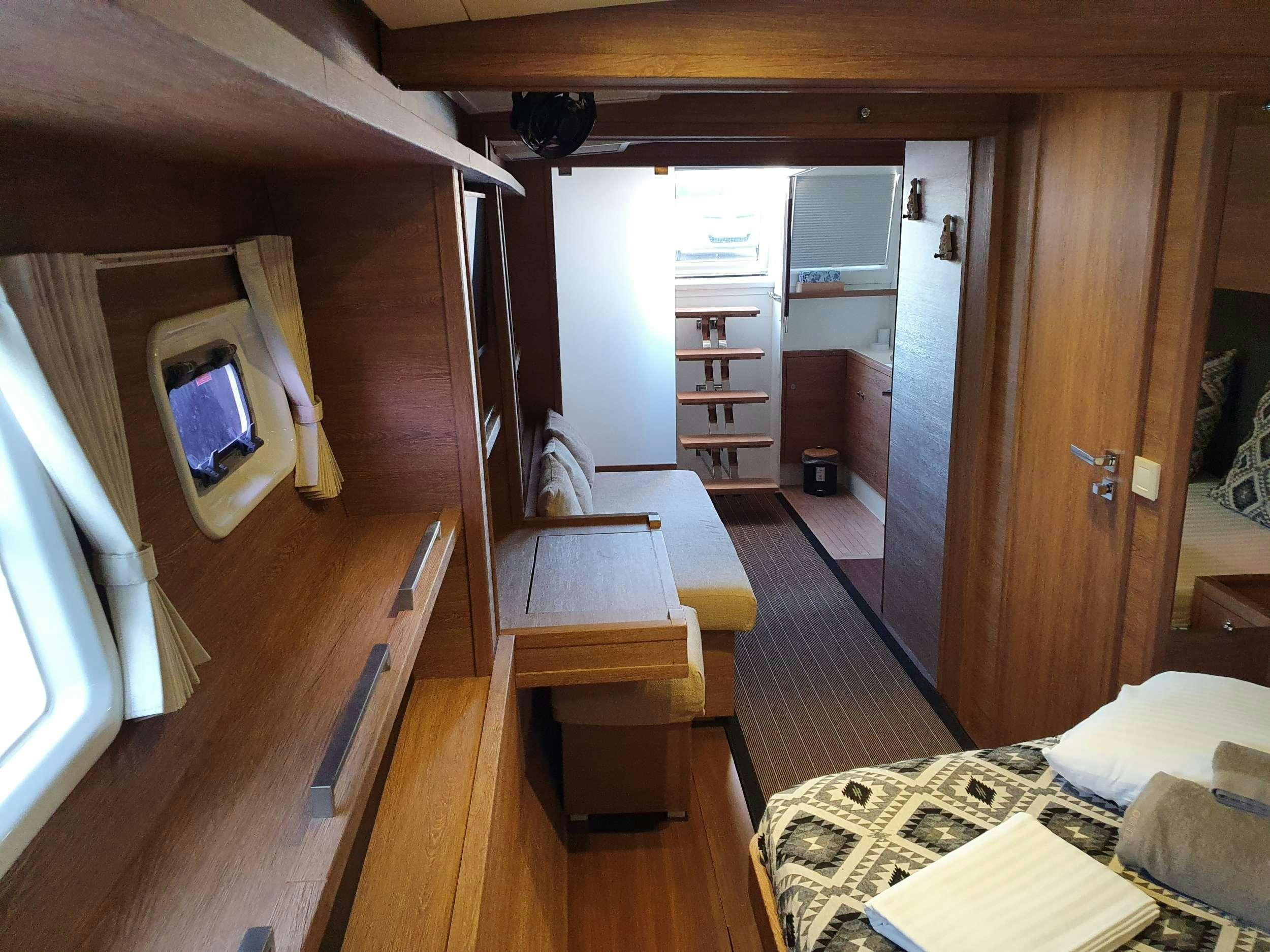 a room with a bed and a desk aboard JARANA Yacht for Charter