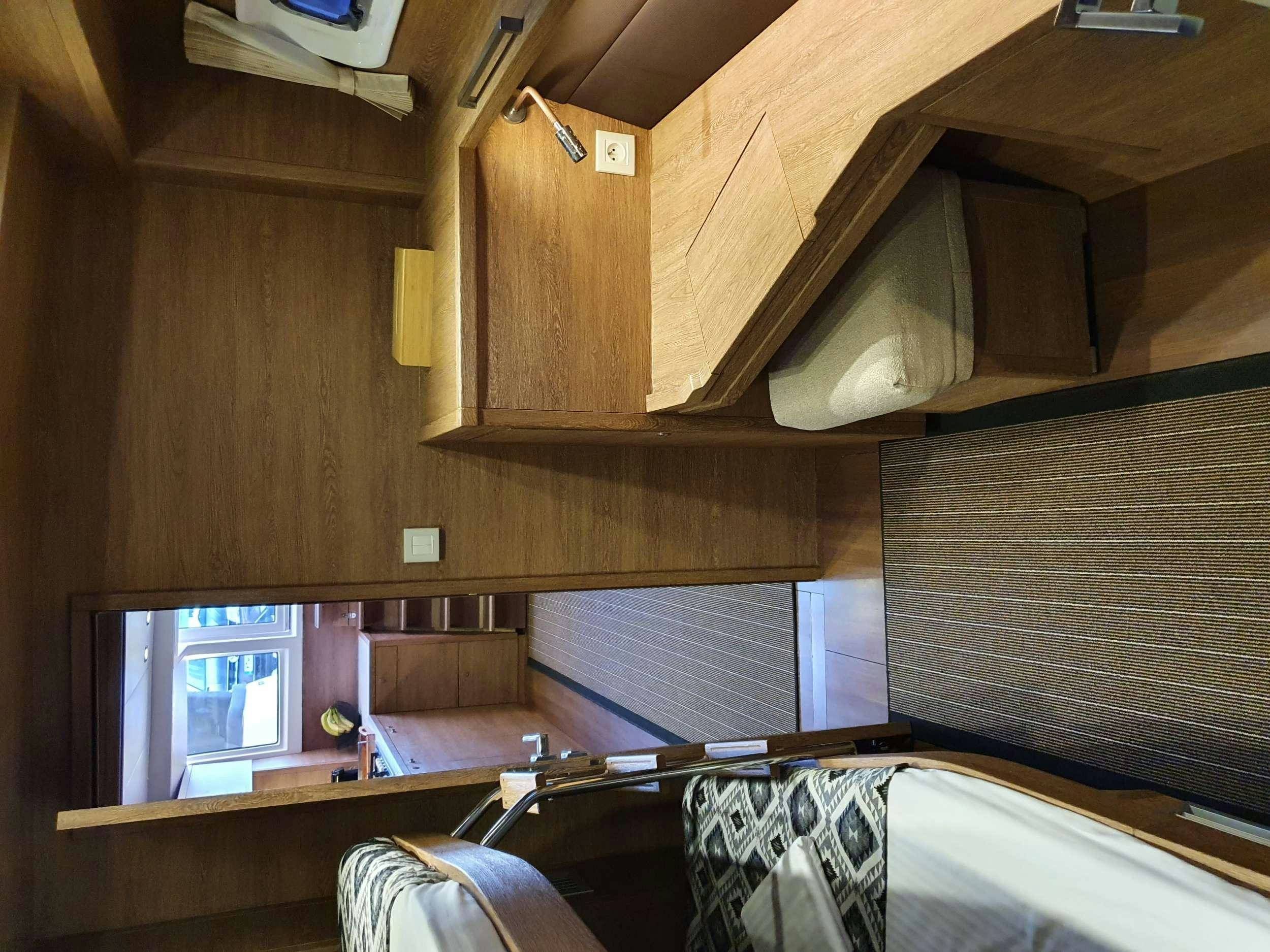 a kitchen with wooden cabinets aboard JARANA Yacht for Charter