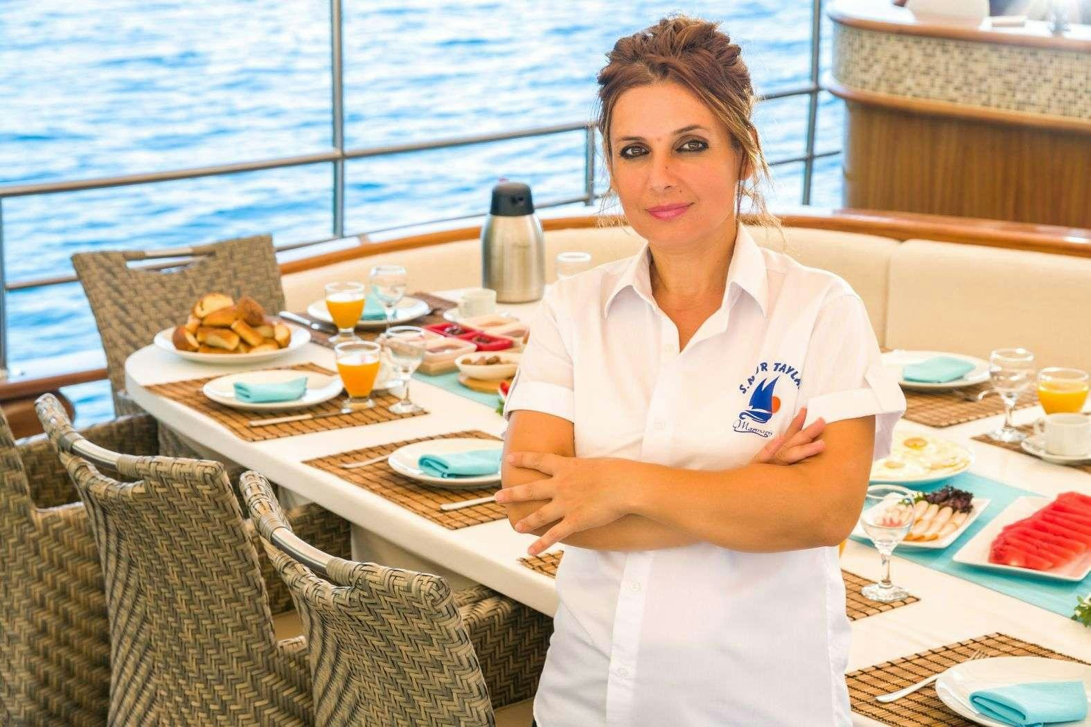 a person sitting at a table aboard S NUR TAYLAN Yacht for Charter