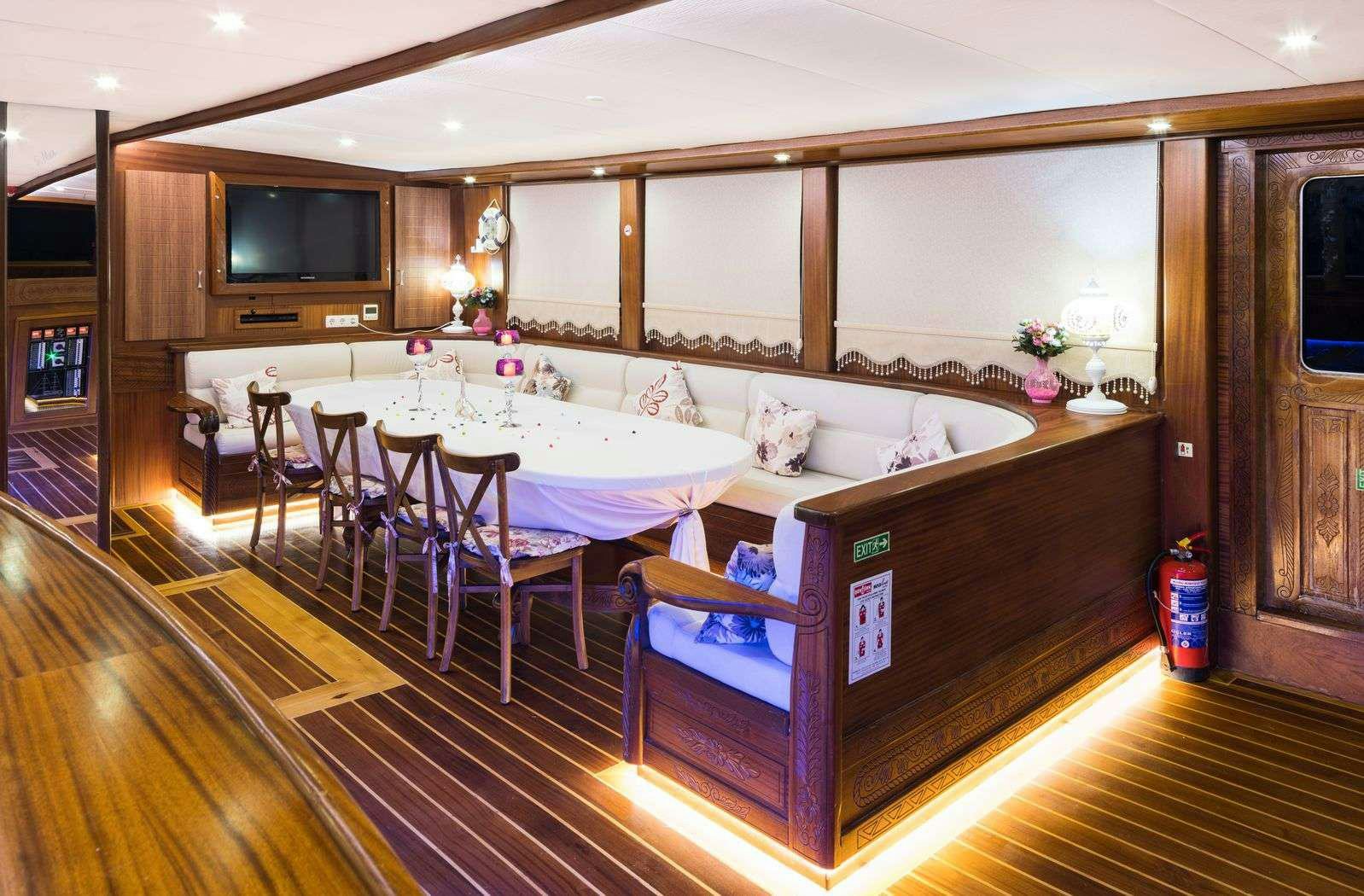 a large kitchen with a dining table aboard S NUR TAYLAN Yacht for Charter