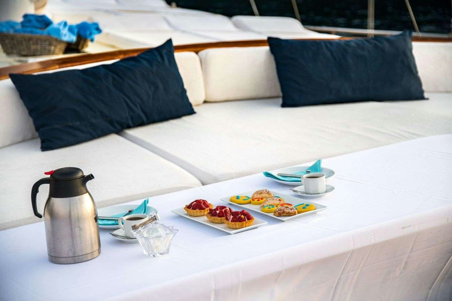 a bed with a tray of food aboard S NUR TAYLAN Yacht for Charter